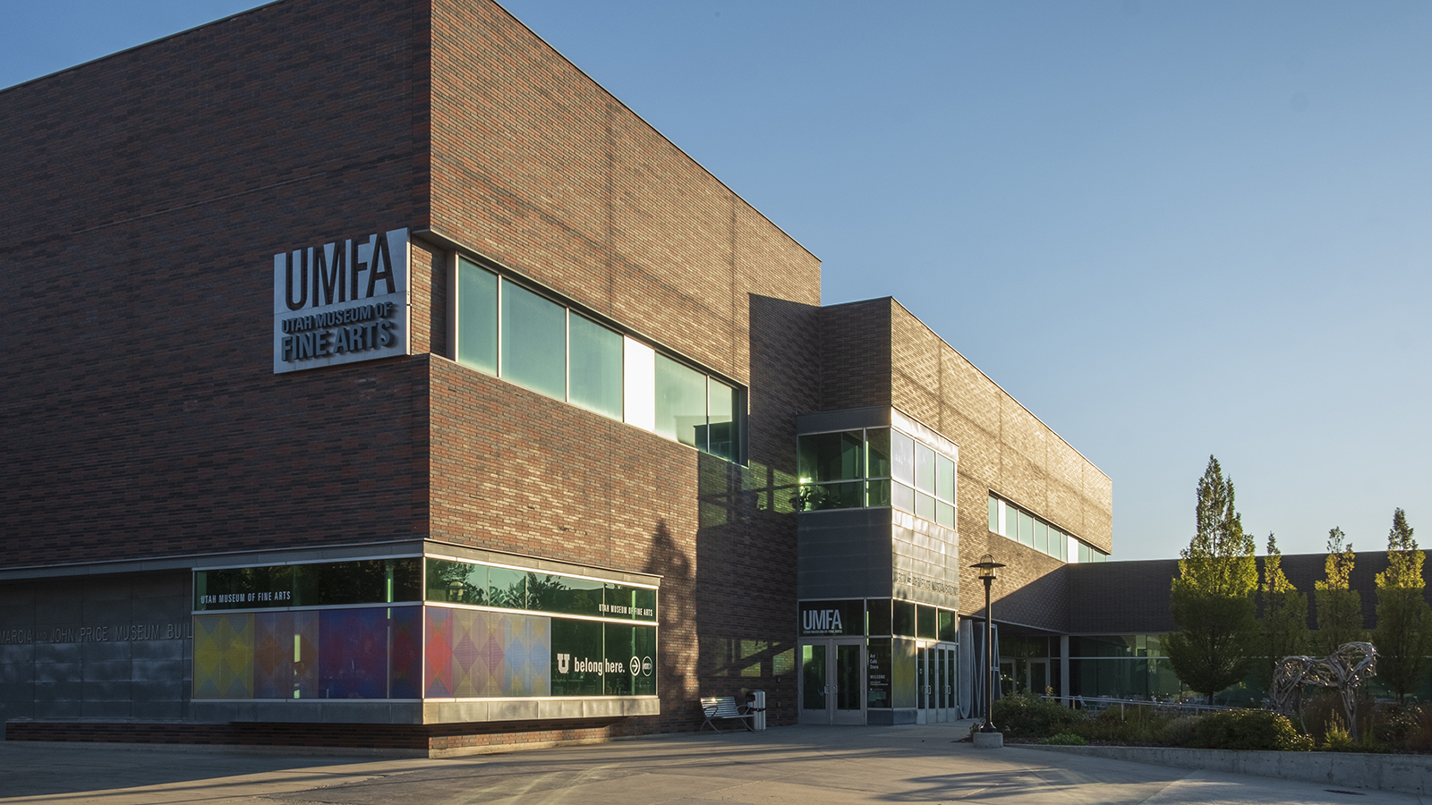 the UMFA museum building exterior at sunset, a two story, modern building with long horizontal windows