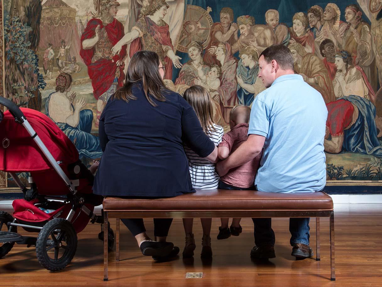 Family viewing a work of art together.