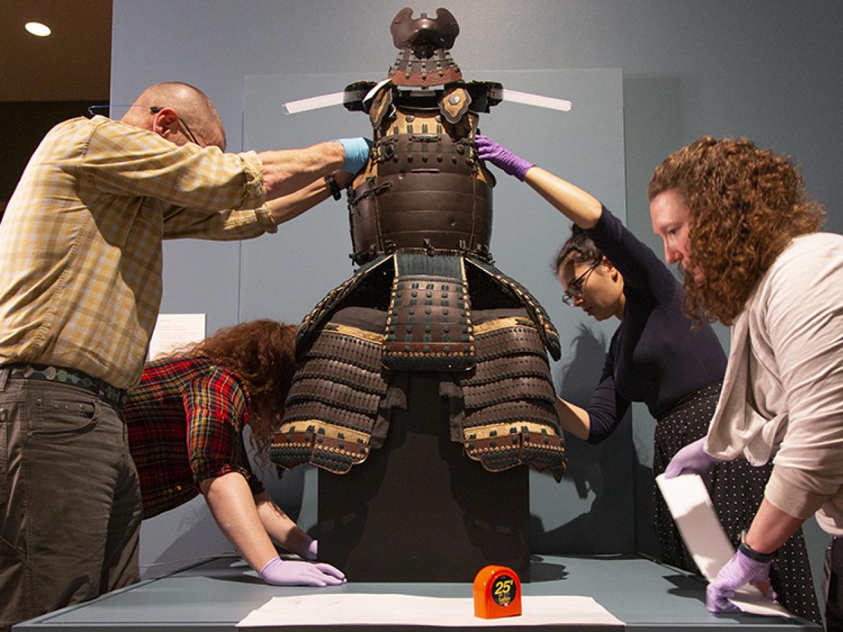 Museum staff install Samurai Armor from Edo Period Japan for Beyond the Divide at the Utah Museum of Fine Arts. 