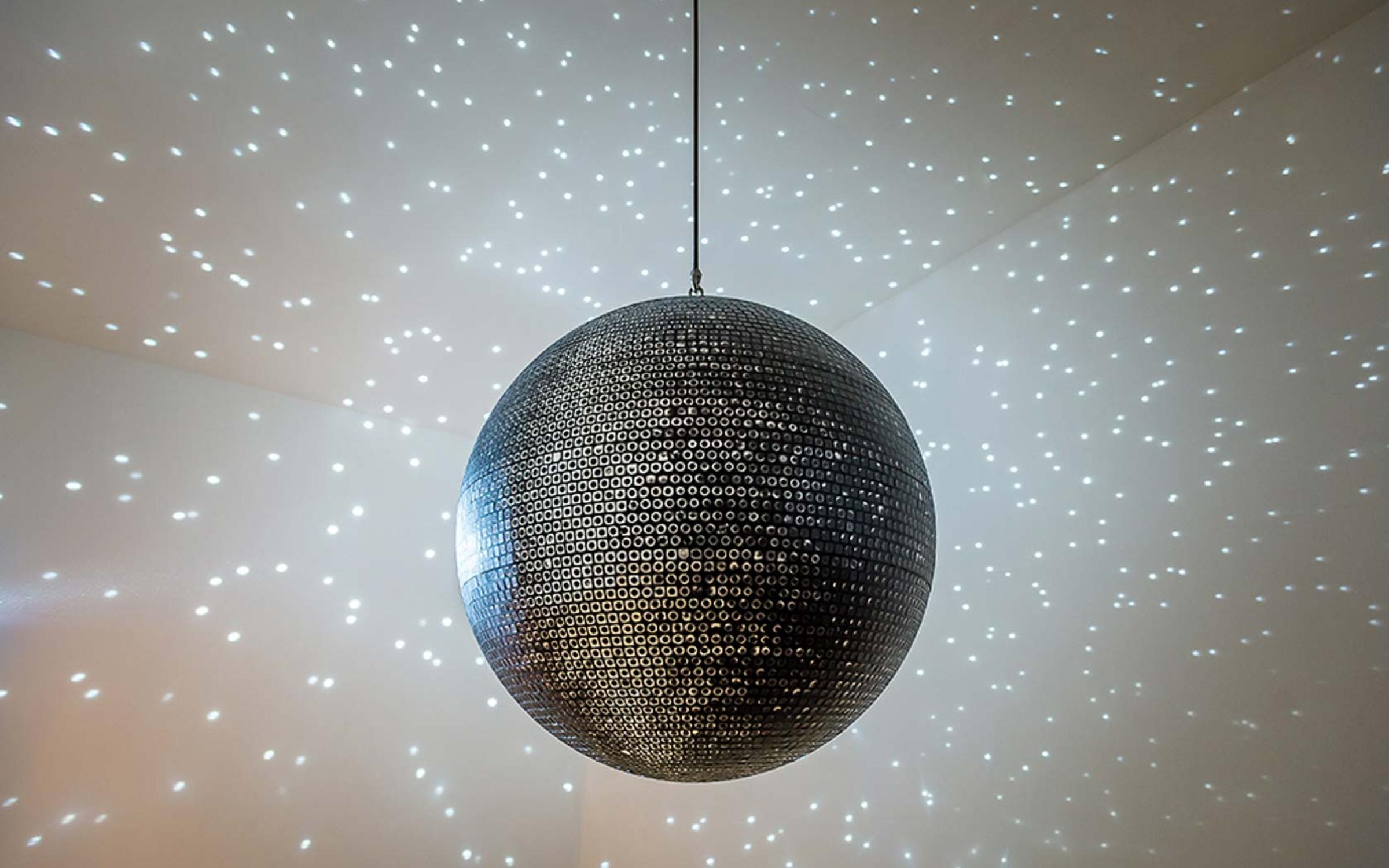 Katie Paterson (Scottish, born 1981), Totality, 2016, printed mirrorball, motor, and lights, 85 cm in diameter, photo © Ben Blackall, courtesy of the Lowry