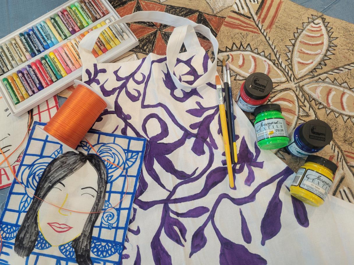 A collection of art projects and art supplies scattered on a table.