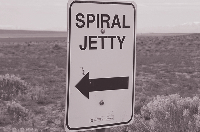 Spiral Jetty road sign Road sing pointing to Spiral Jetty with sagebrush dessert in the background.
