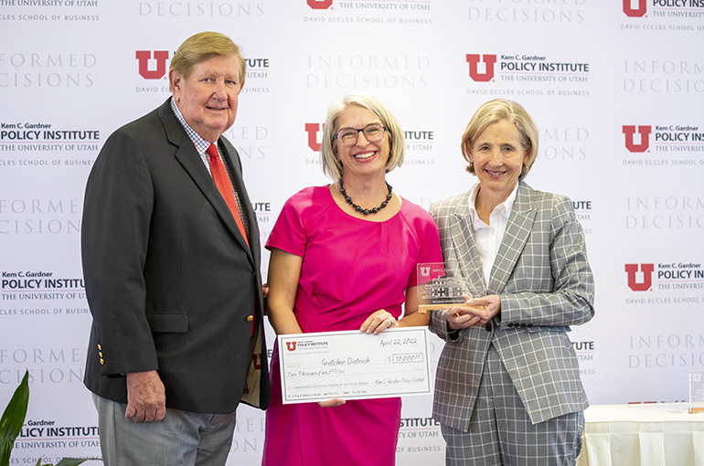 Gretchen Dietrich receiving an award from Institute Director Natalie Gochnour and Kem C. Gardner