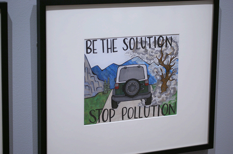 a framed poster that says be the solution stop pollution with a drawing of a jeeps tailgate with smog surrounding the car
