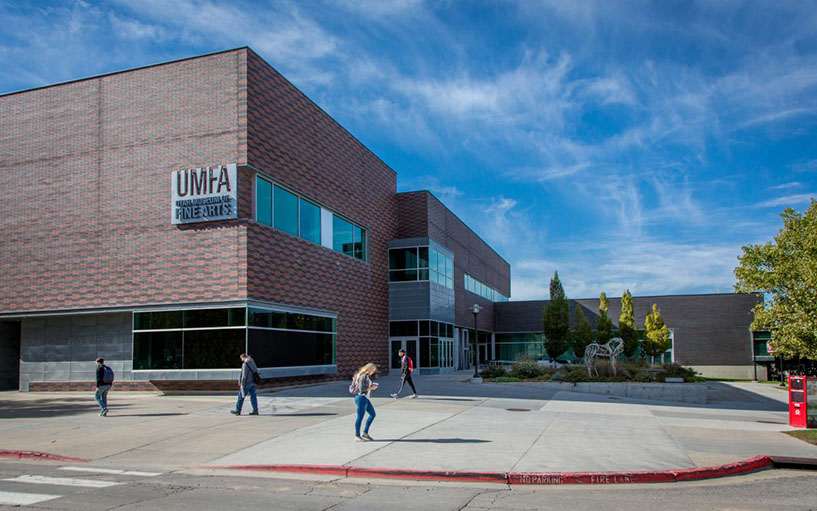 The exterior of the UMFA, students walk past the building.