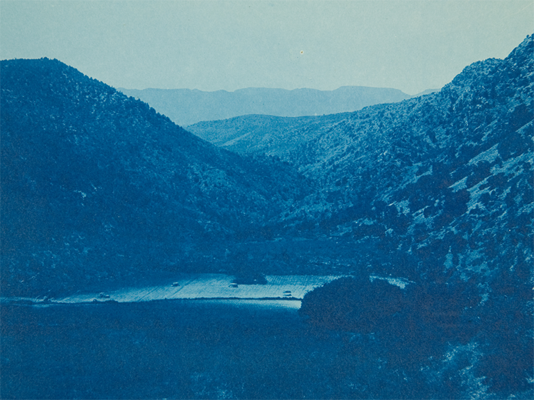 A blue cyanotype photo of a valley.