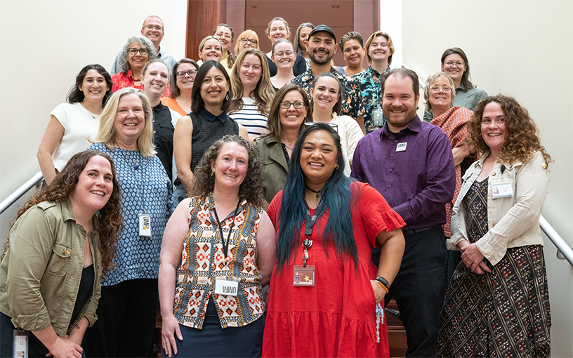 The staff of the UMFA standing on the stairs smiling.
