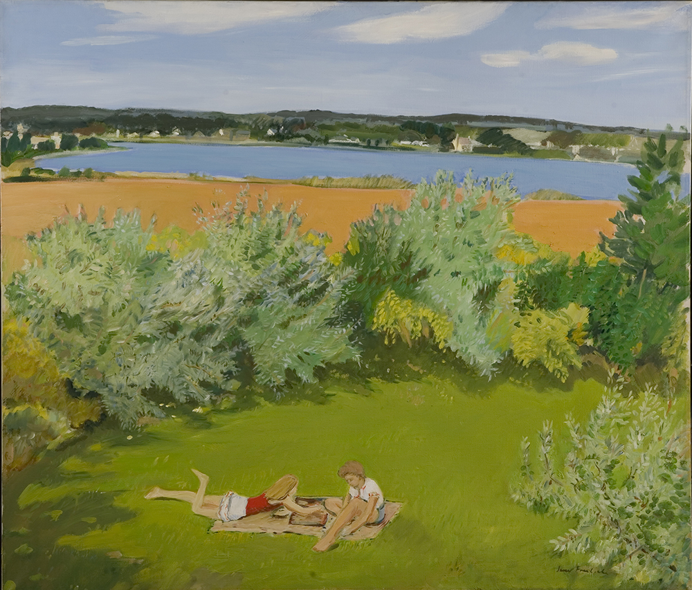 Two small figures lay on bright green grass in the foreground. There is a blanket under them and they are playing backgammon. The grass is surrounded by green bushes. In the middle ground is brown sand along the banks of a blue lake. Beyond the lake in the background are low hills with impressions of houses along the far banks of the lake. Beyond the hill is a blue sky with high white clouds. 