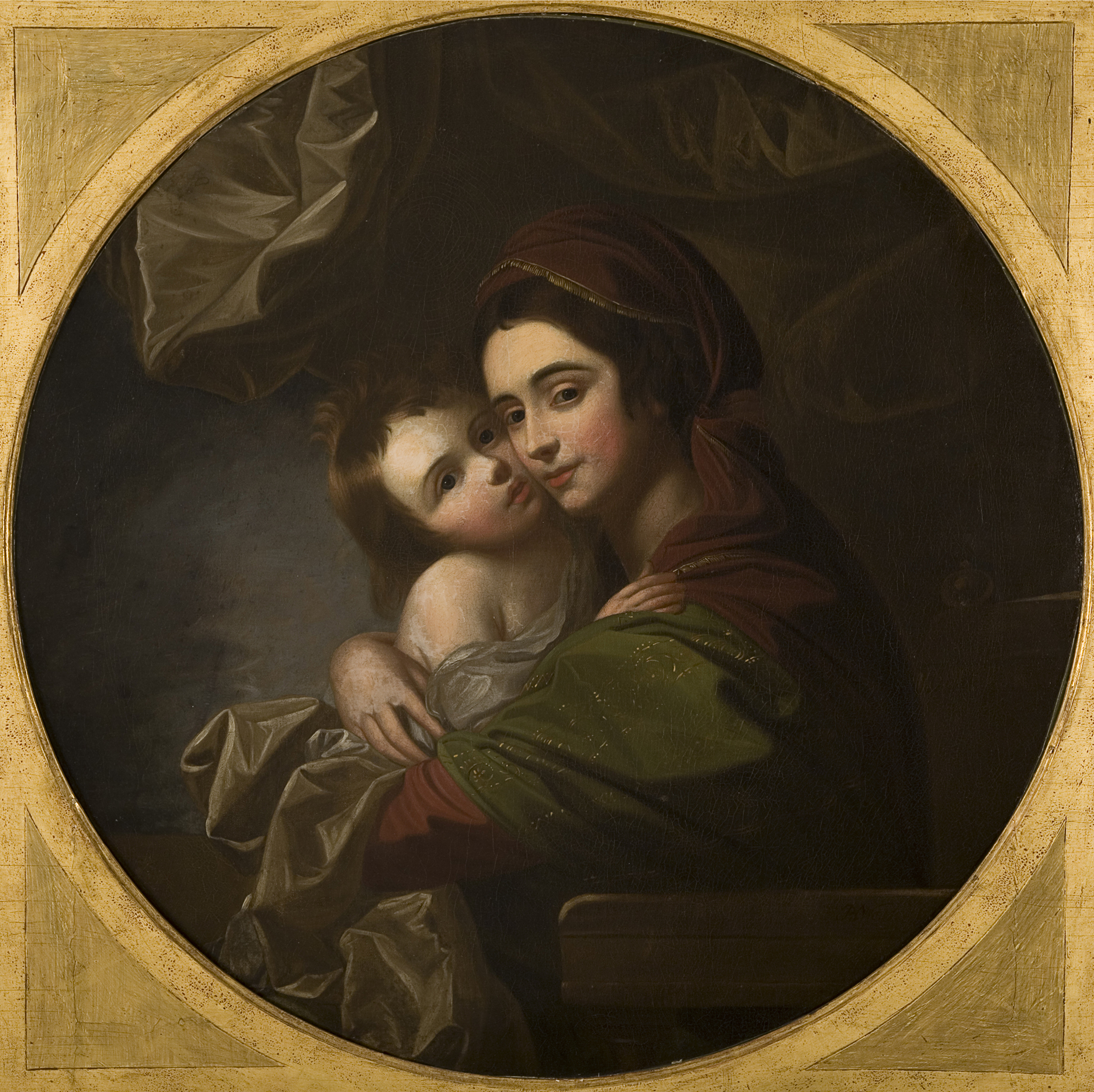 A portrait of a mother and child in a round gold frame