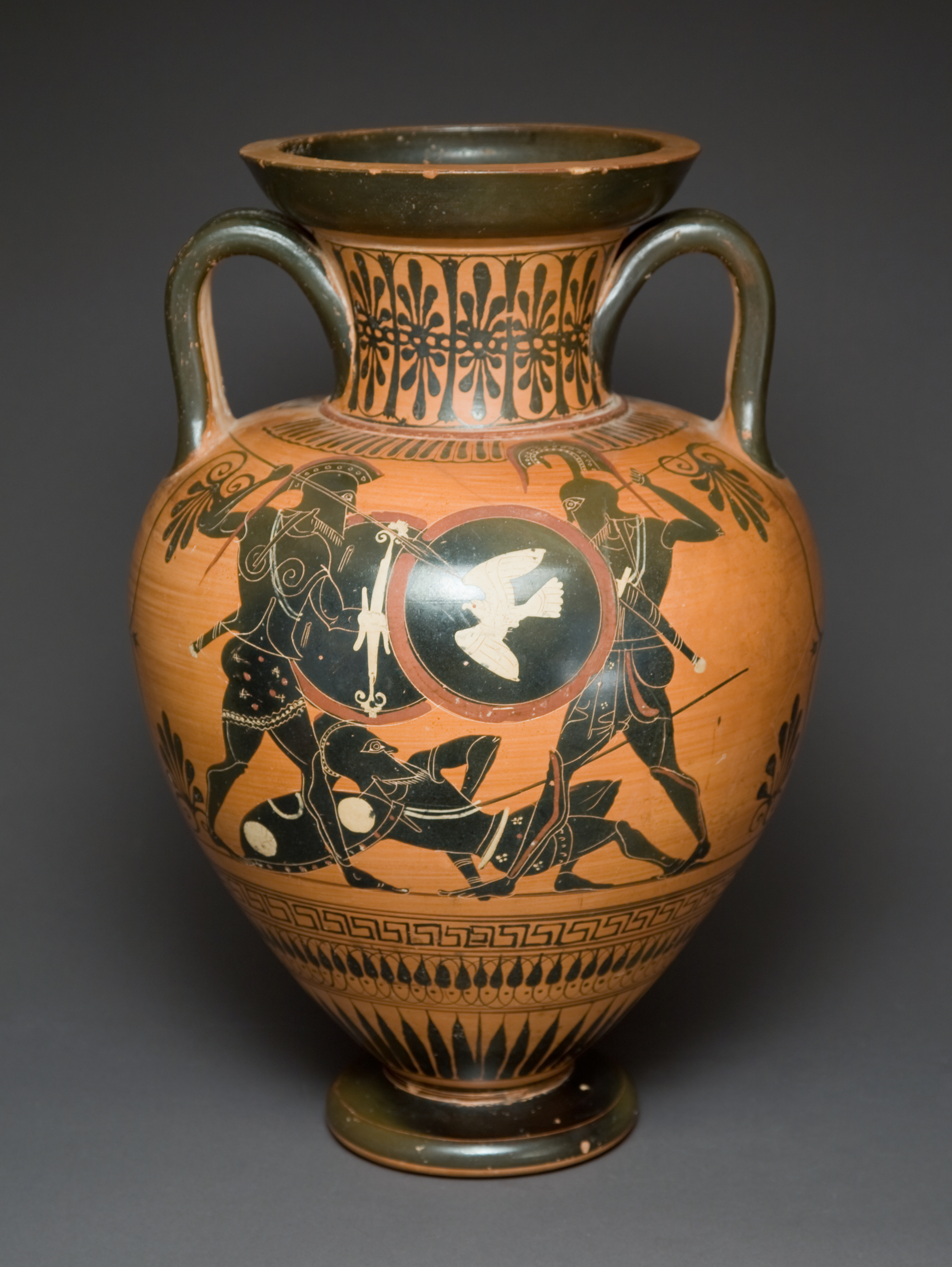A red and black two handled jar with an image of soldiers and a white bird painted on it.