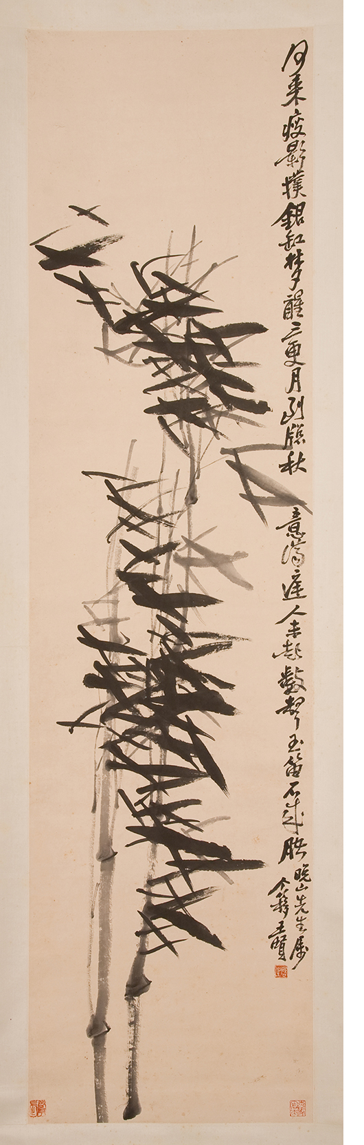 A tall rectangular ink painting of bamboo leaves and stalks. The leaves are quick brushstrokes. A line of Chinese text runs down the right side of the painting.