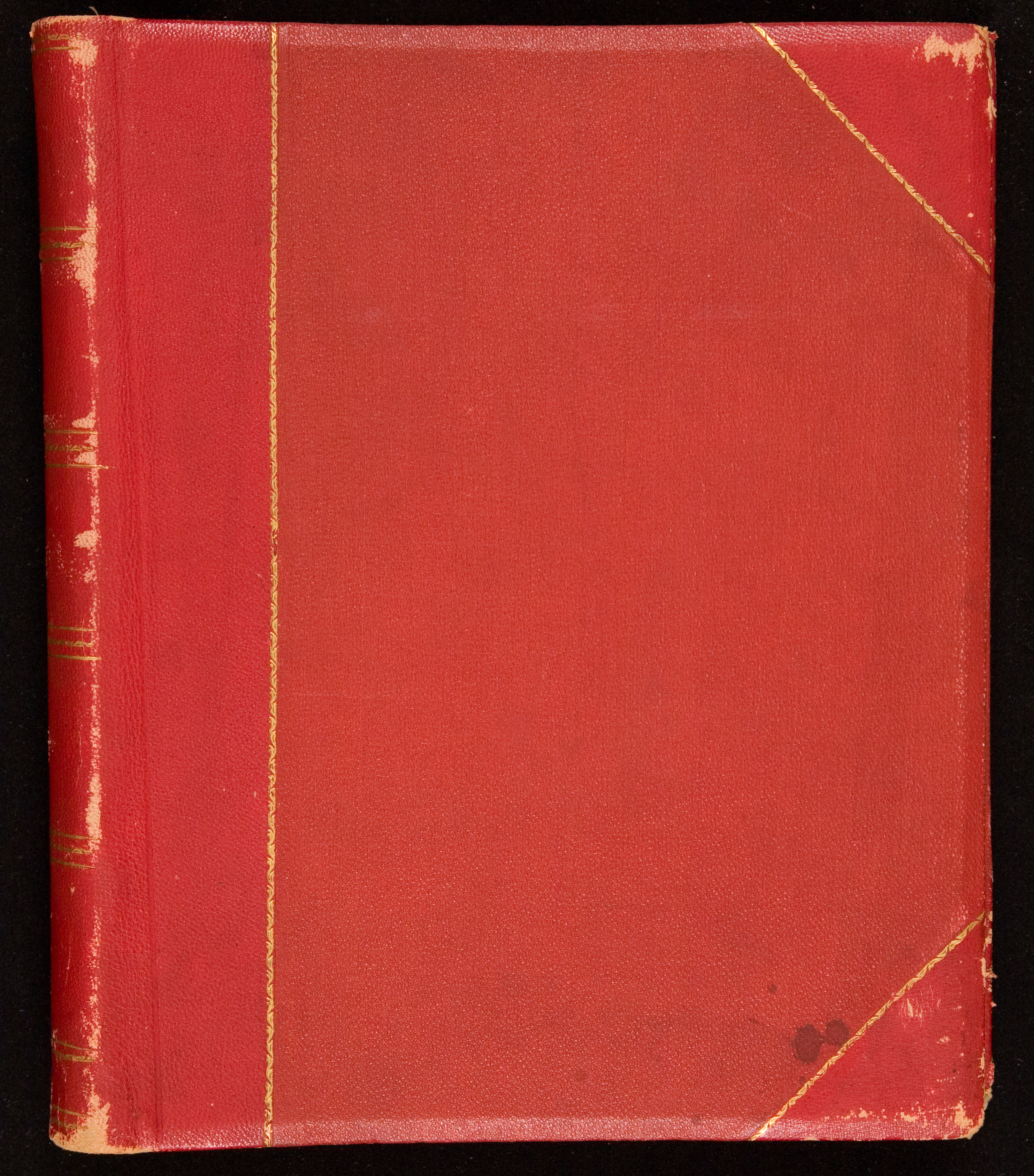 A worn red-faux leather album.