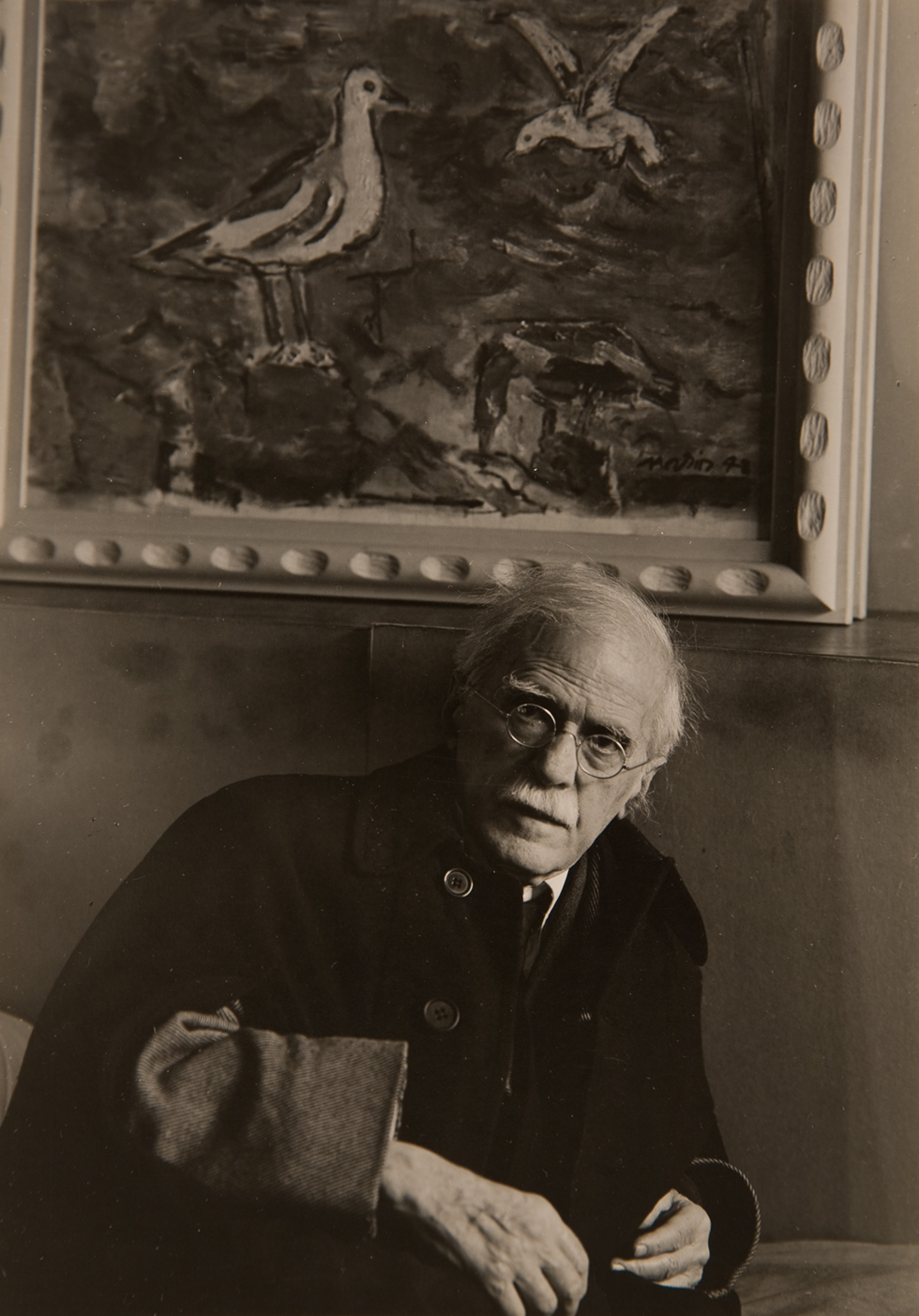 A black and white portrait of a man sitting.