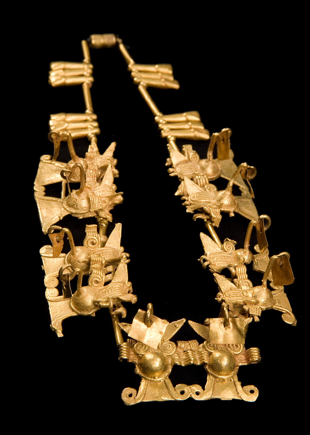 a gold necklace made of bat sculptures
