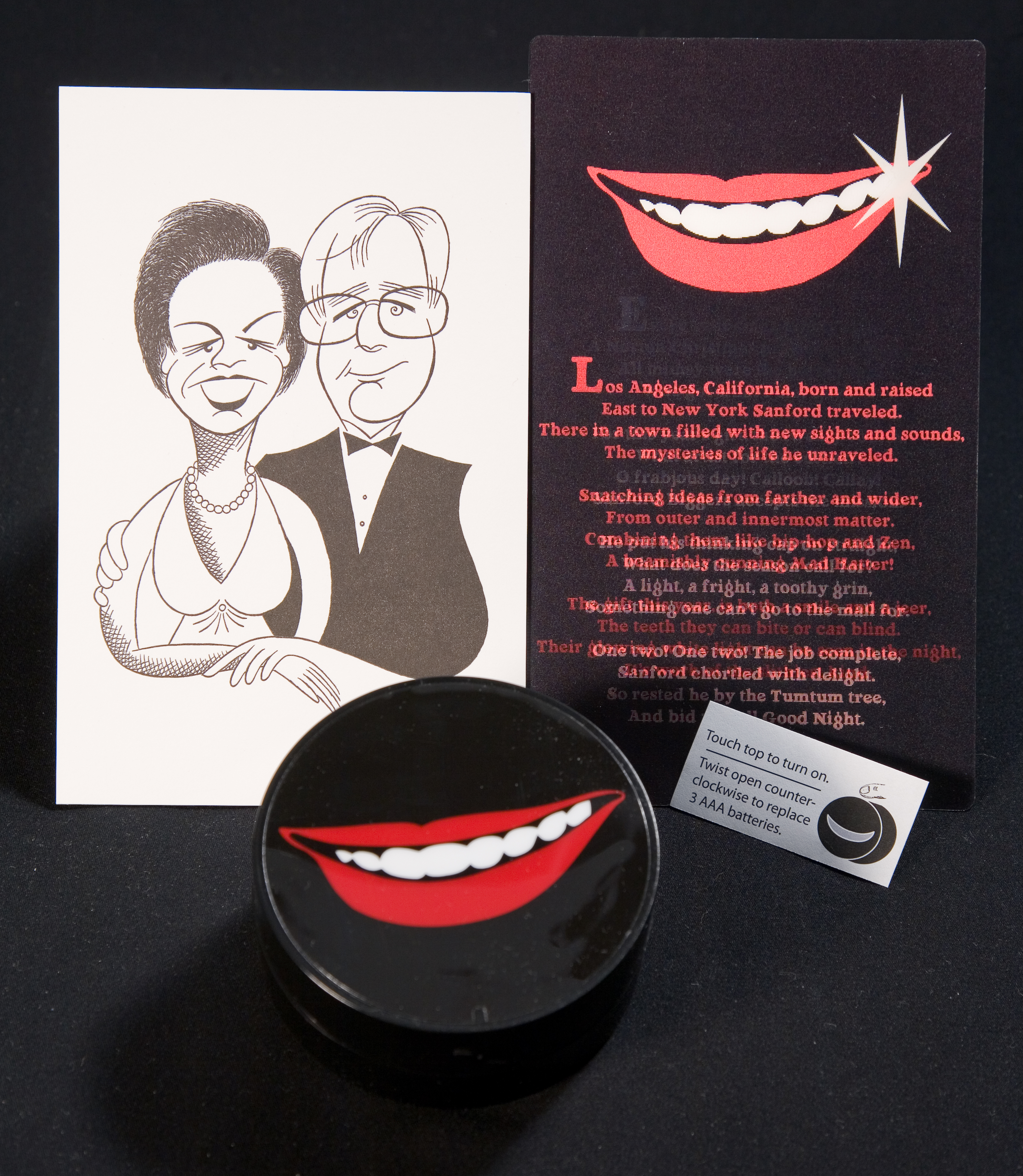 A collection of objects including a caricature of a couple, a round box with red lips and white teeth smiling and a card with text and the same smiling lips.