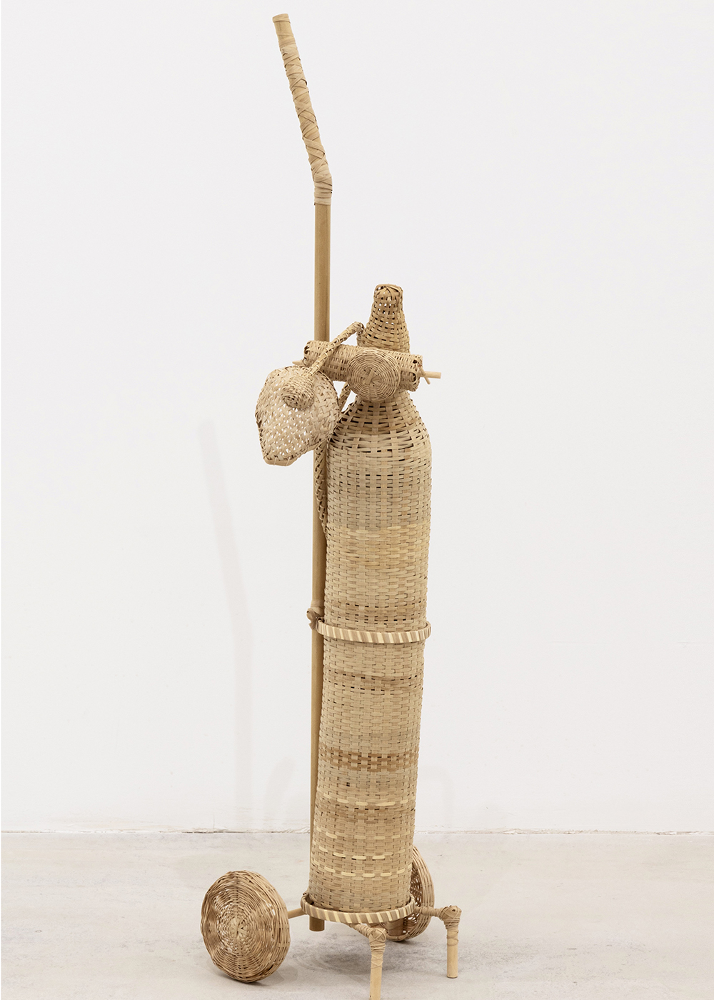 sculpture of what looks like a modern day medical air tank woven from white ash wood fibers