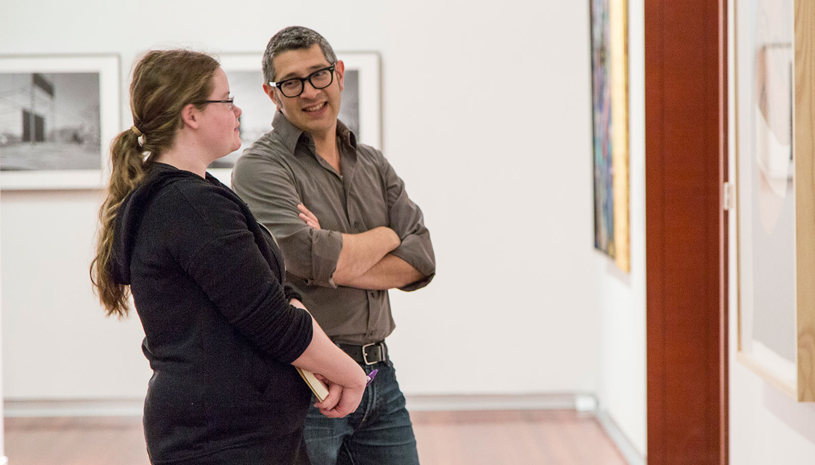 Student and professor talking in gallery.