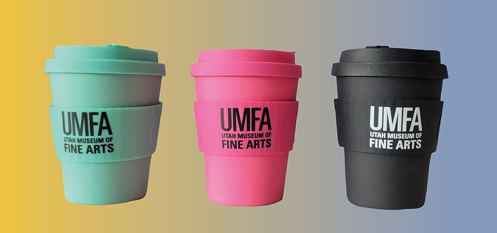 three reusable coffee cups with the UMFA logo on them