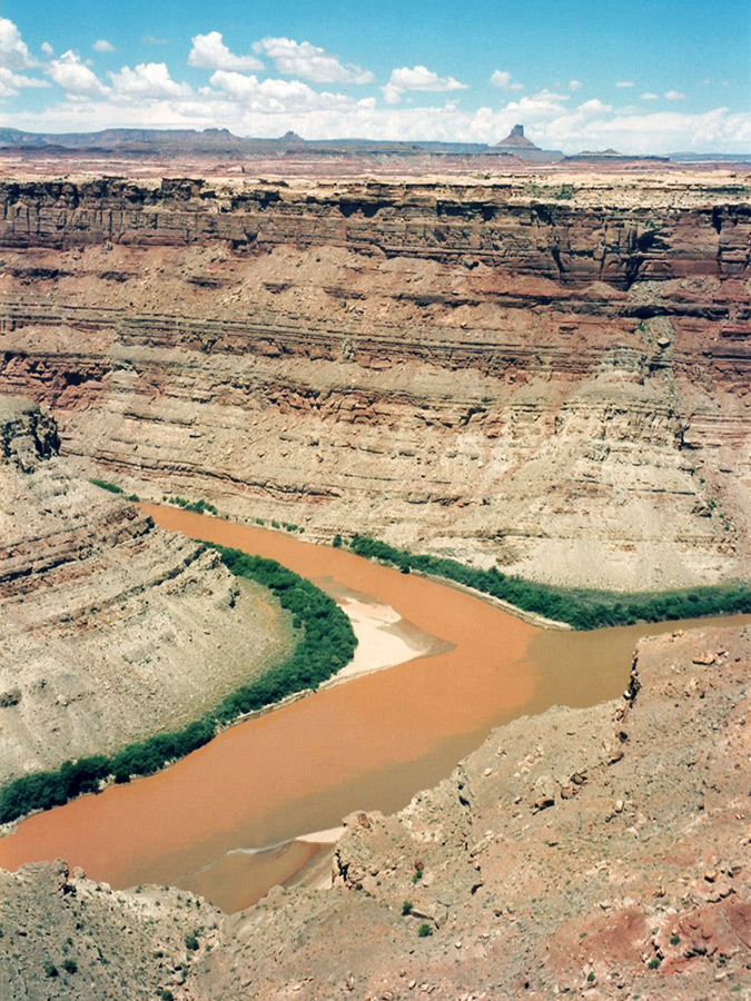Confluence of the Green River and Colorado River in Canyon Lands, Utah. Red dessert cliffs surround the green and red rivers and they come together.