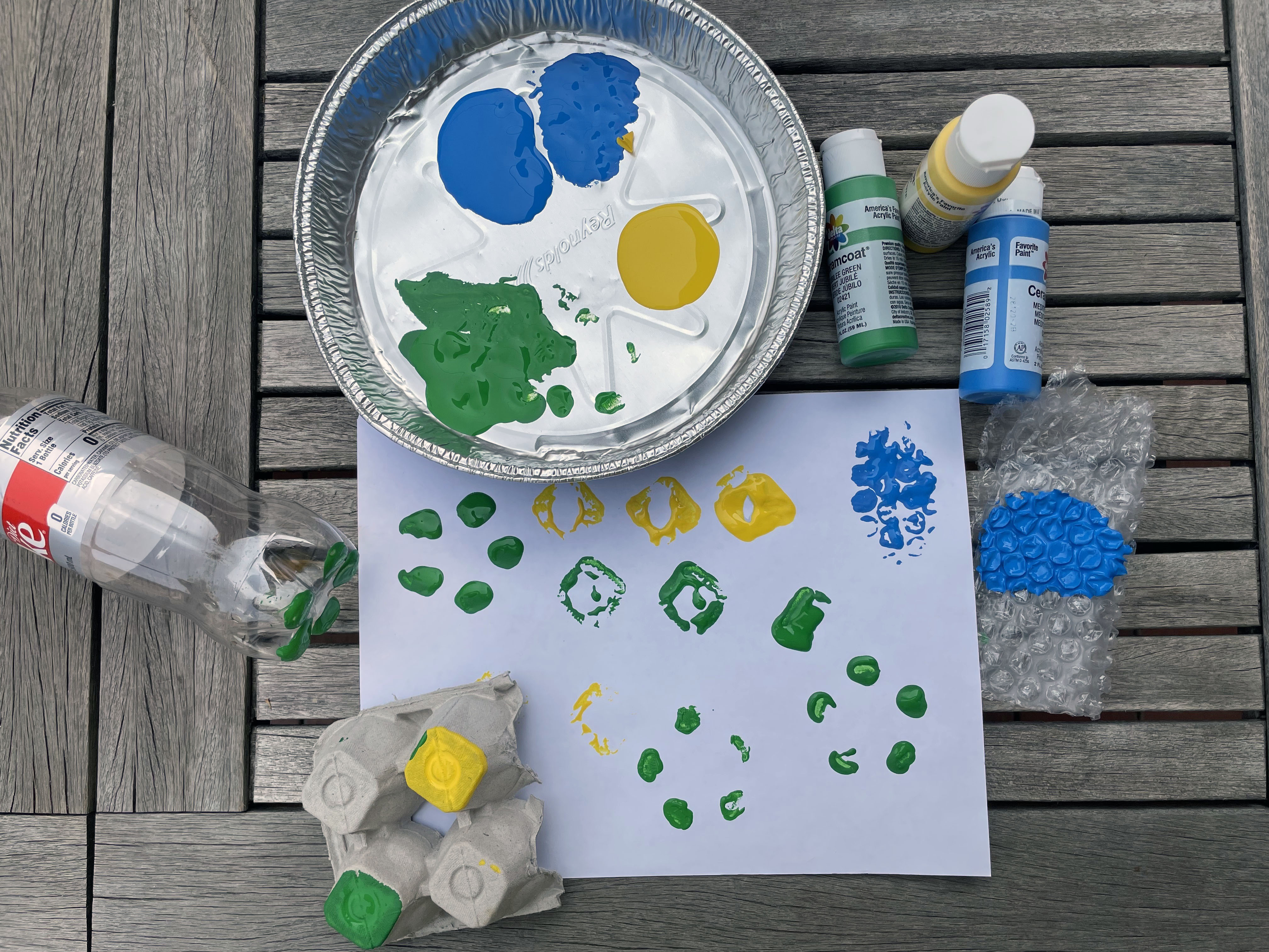 a blue, green, and yellow print made with egg cartons, bubble wrap and plastic bottle