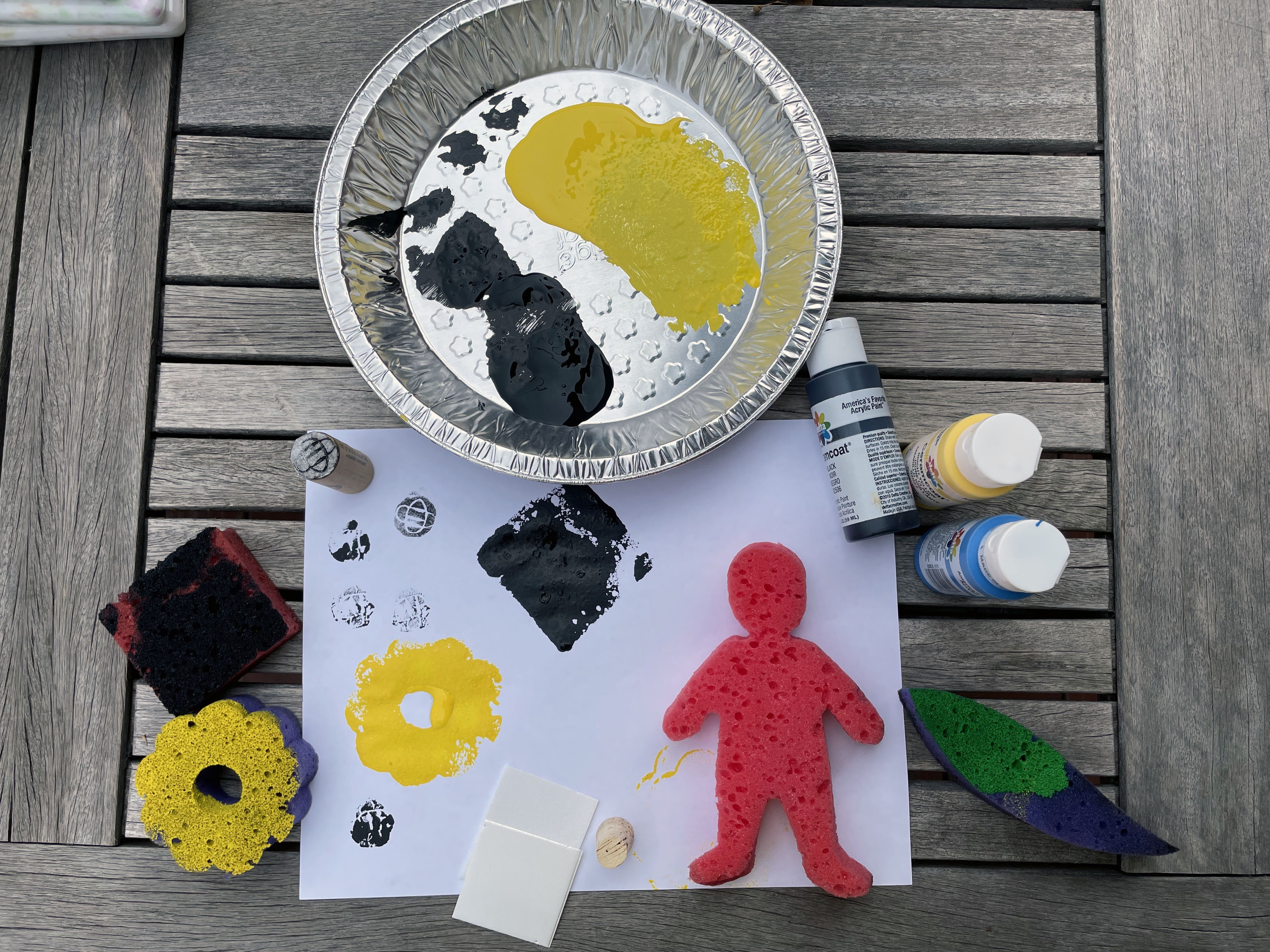 stamps made out of sponges, red paint in a pie tin and with paper