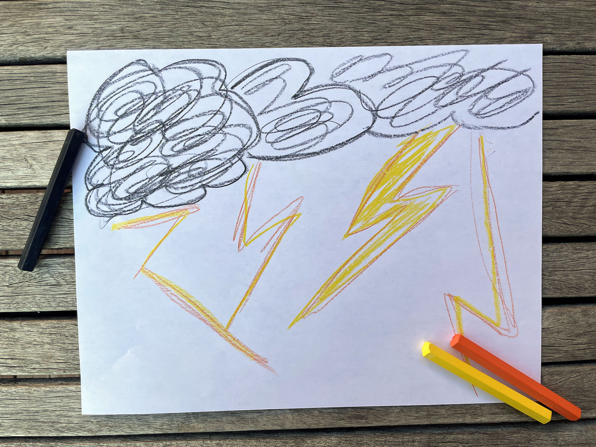 a drawing of dark clouds with yellow lightening bolts 
