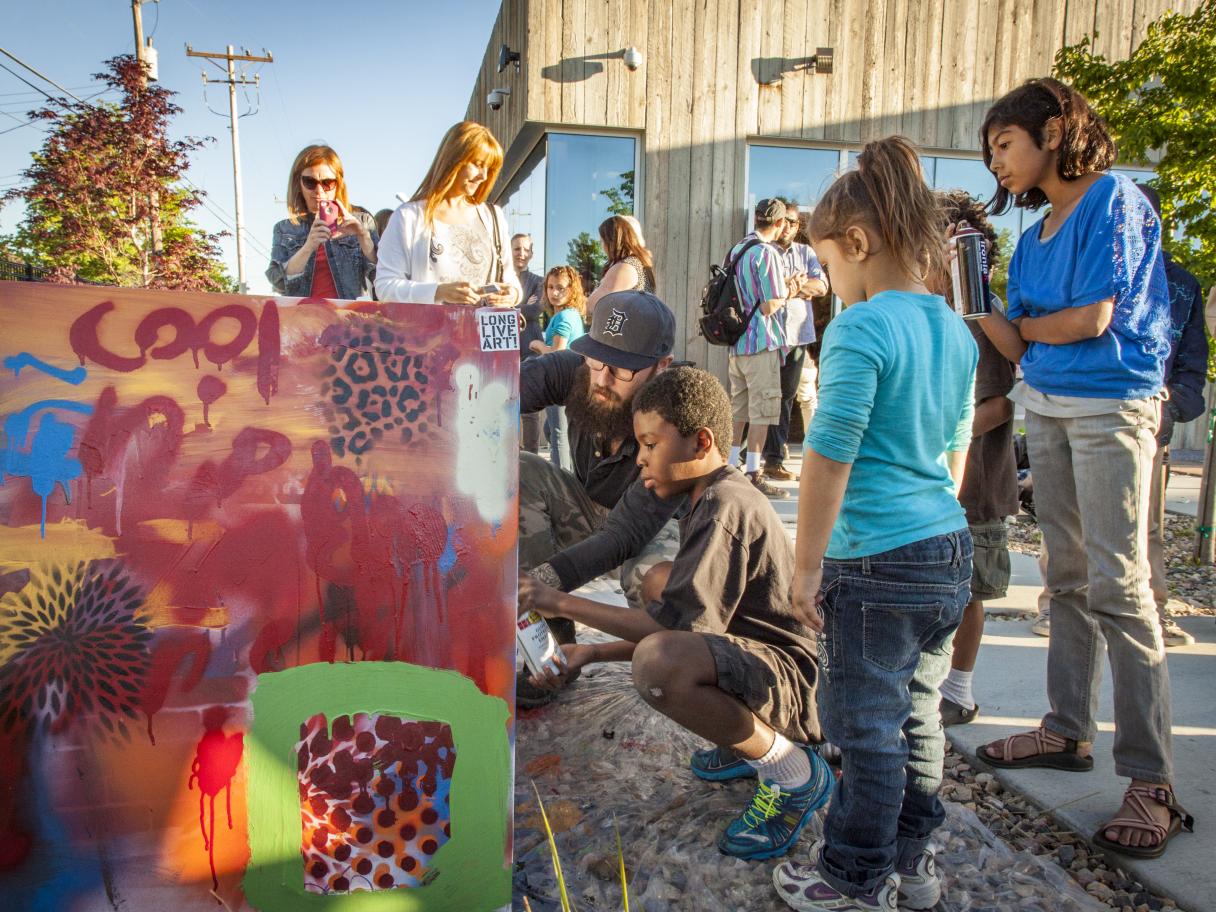 A group of people spray paint together