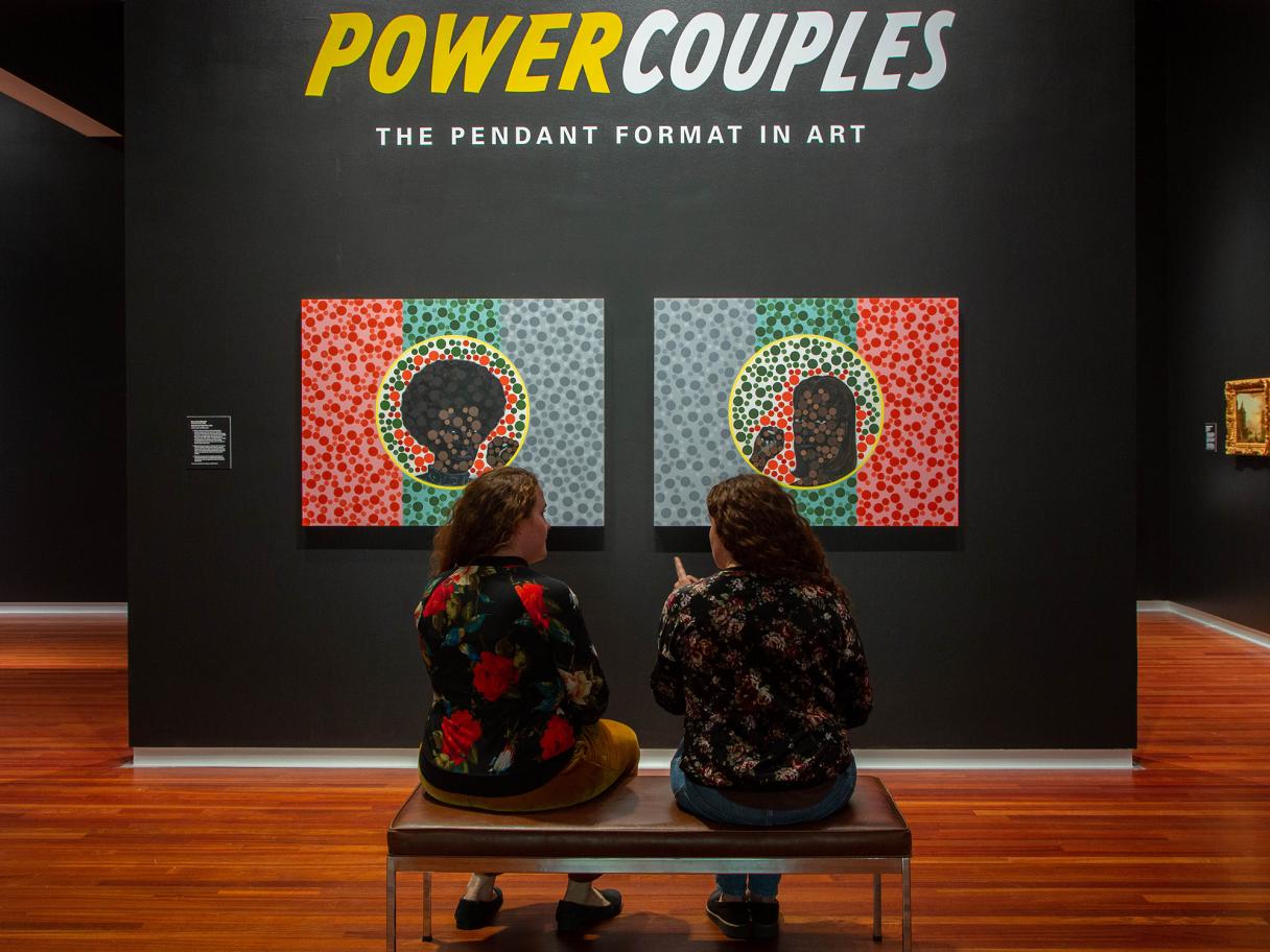 Twins sit discussing Kerry James Marshall's Color Blind Test in Power Couples: The Pendant Formant in Art at the Utah Museum of Fine Arts