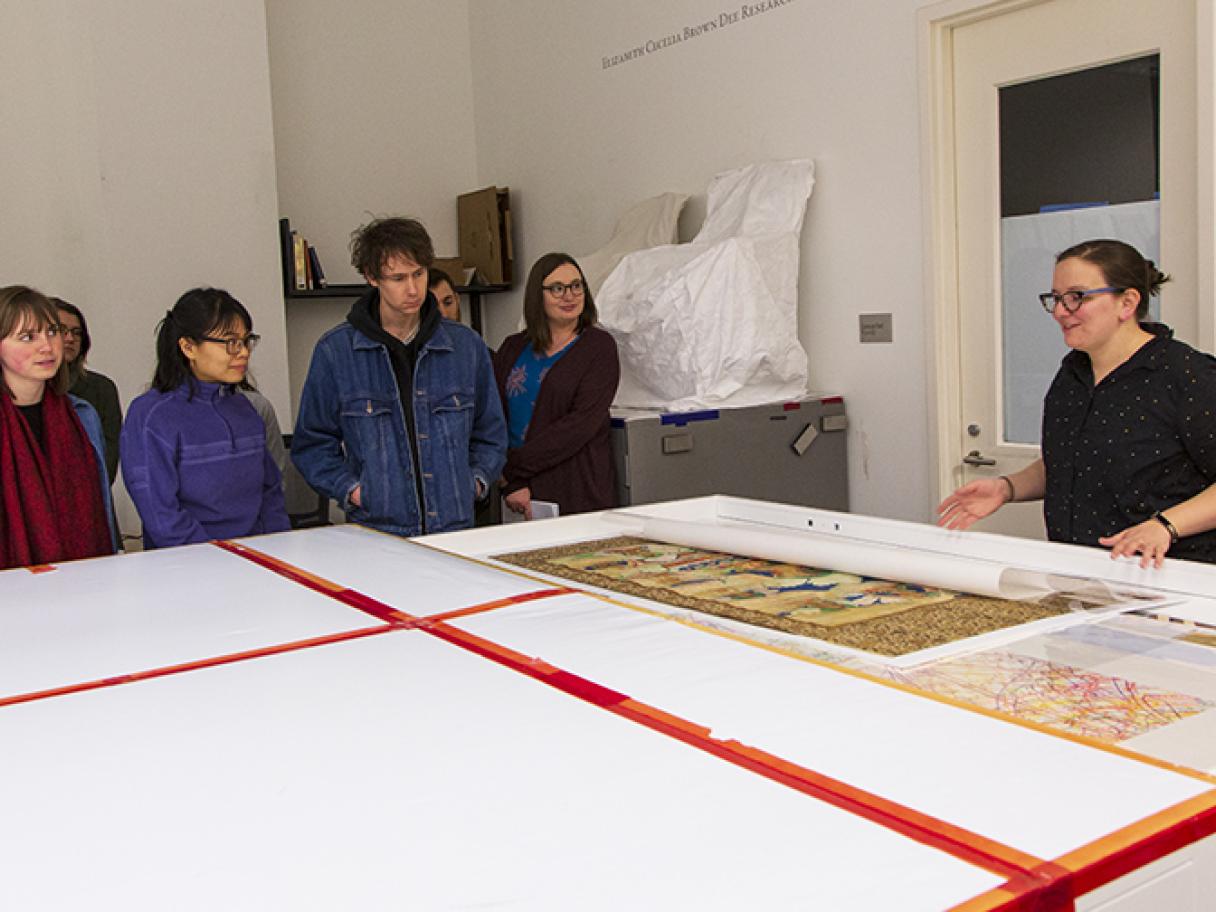 Students viewing objects in the Utah Museum of Fine Arts collection's storage. 