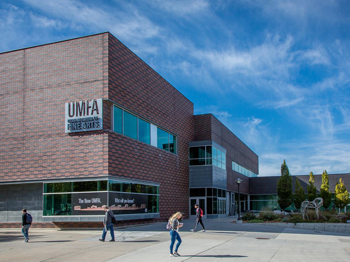 UMFA building exterior students walking in front blue sky