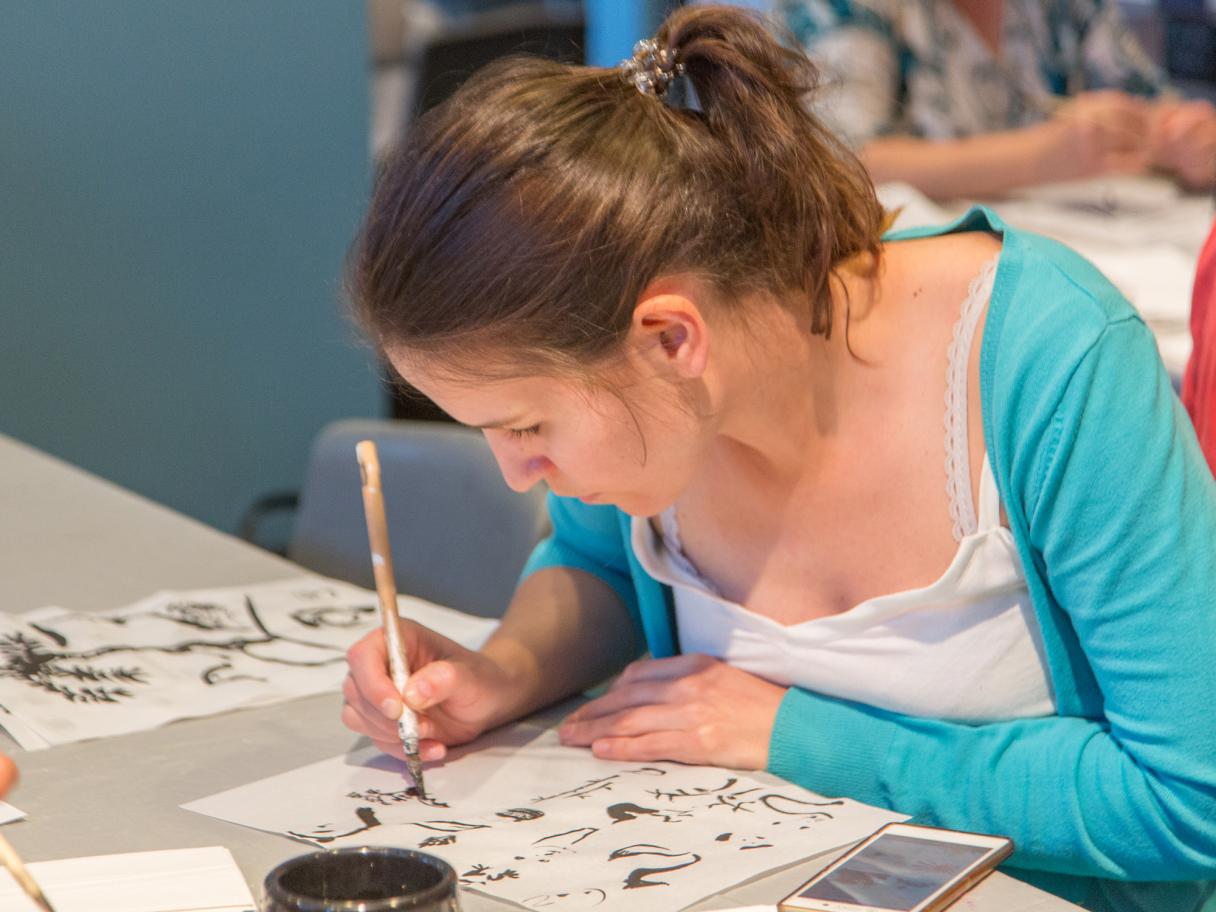 Women practicing Sumi-e at UFMA Open Studio