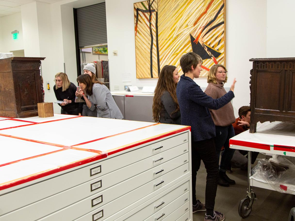 A U of U Art History class views furniture objects during a visit to the UMFA's collections storage. An Art history class views furnature objects during a visit to collection's storage at the Utah Museum of Fine Arts.