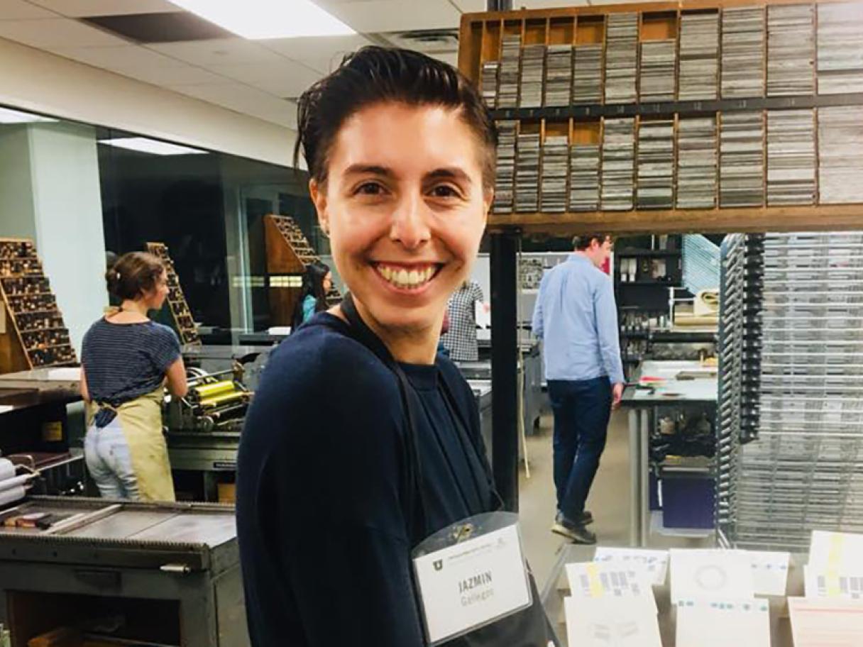 Jazmin Gallegos smiles at the camera she stands in the books art studio at the University of Utah