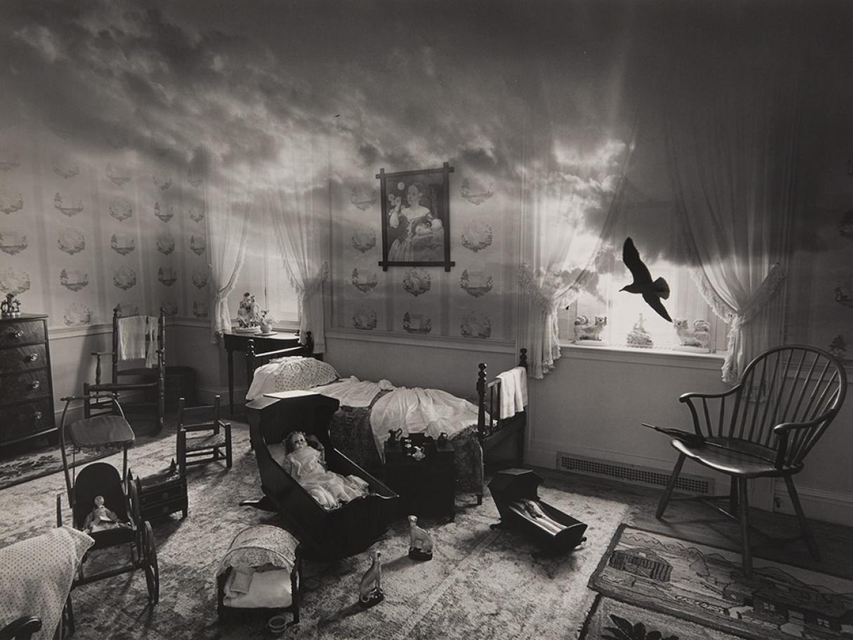 black and white photographic collage of a bedroom with a sky as the ceiling