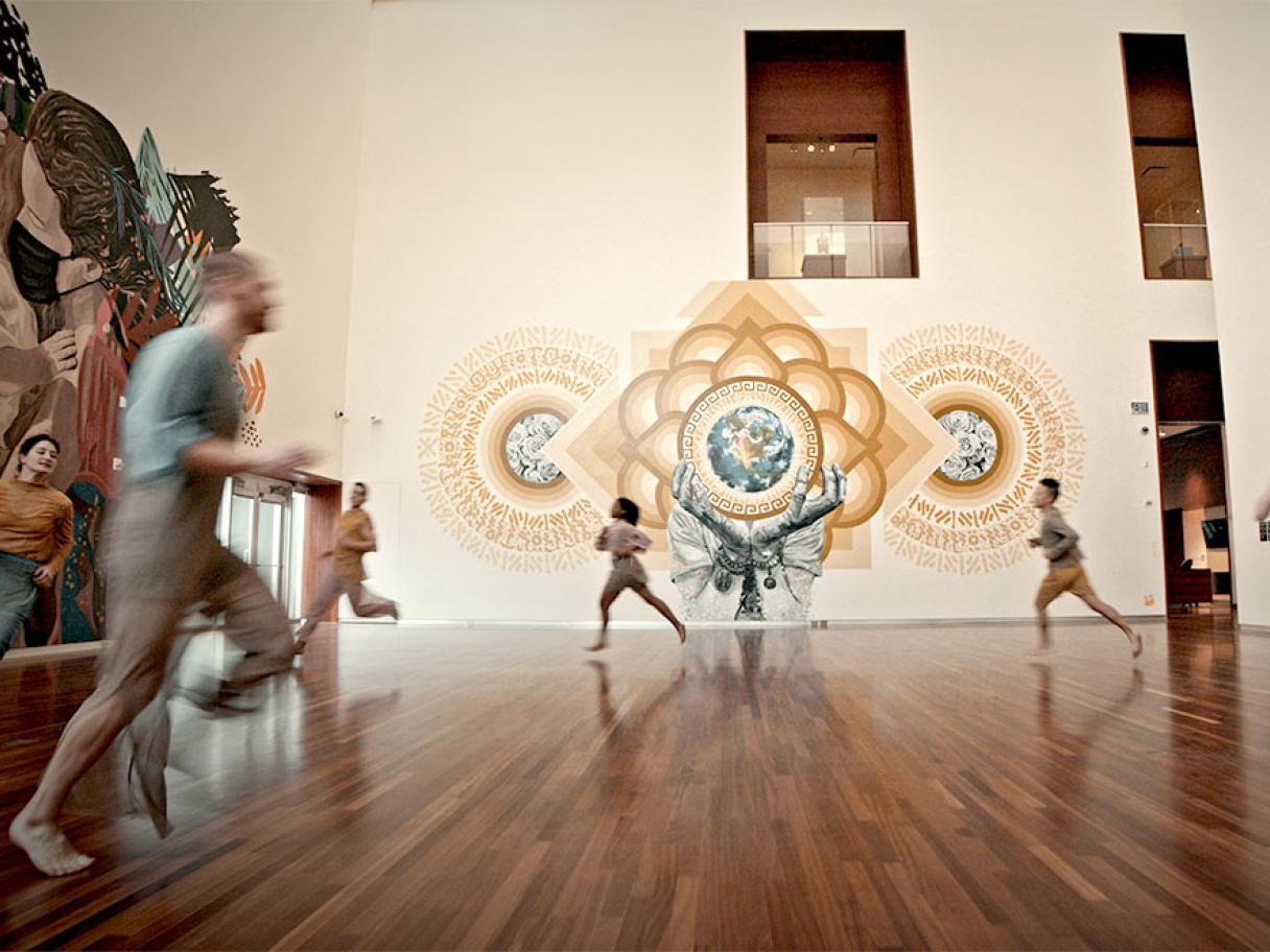 a group of dancers leaping trough the UMFA Great Hall