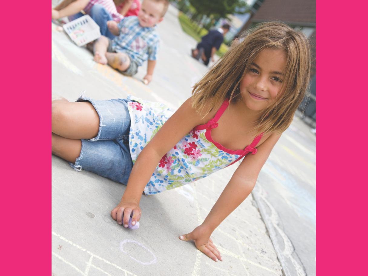 A girl drawing with chalk