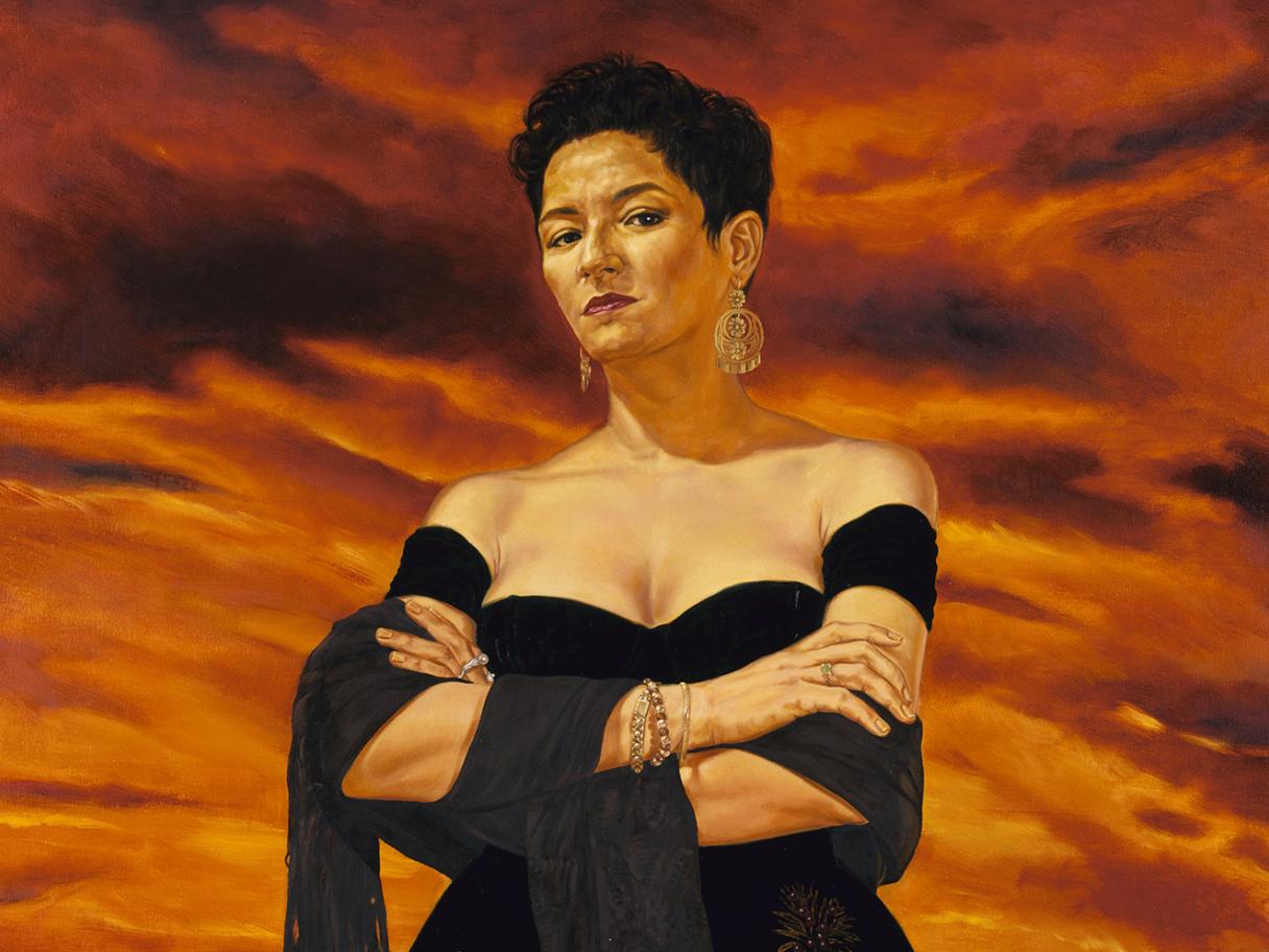 A painting of a  latina woman standing against an ominous red sky, her arms are folded acroos her chest and she slooks down towards the viewer, she is wearing a black off the shoulder gown. 