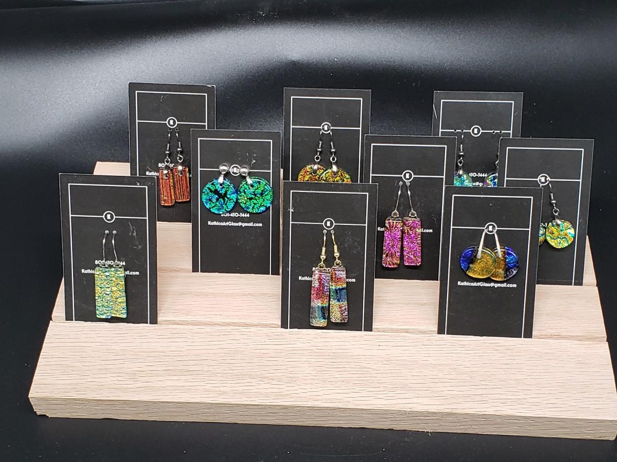 a selection of fused glass earring on black cards