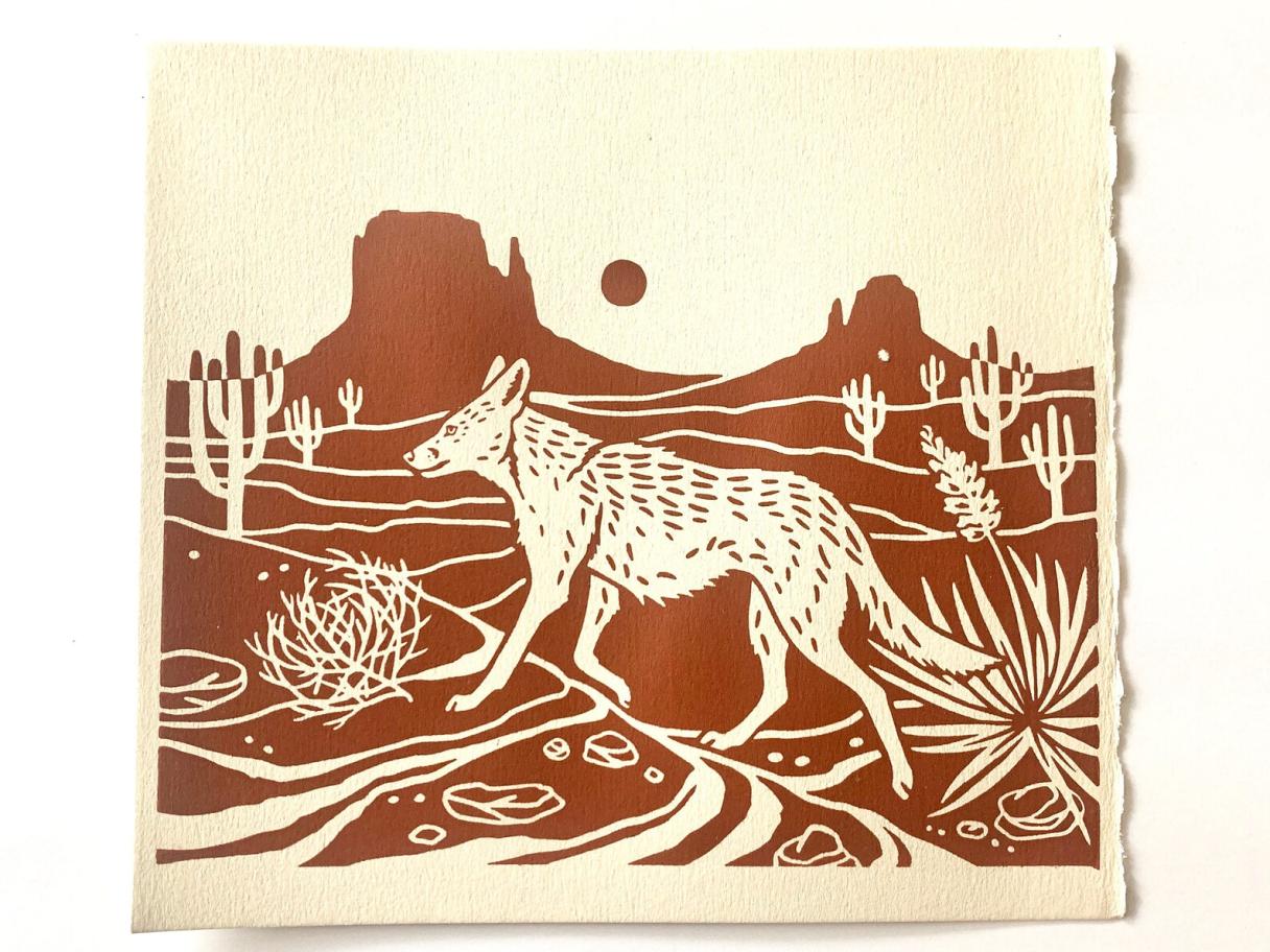 a monotone screen print of an illustration of a coyote walking through a desert