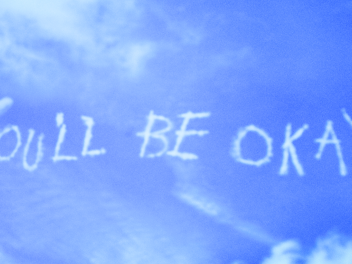 A blue sky with faded white clouds spelling the words "You'll be okay"