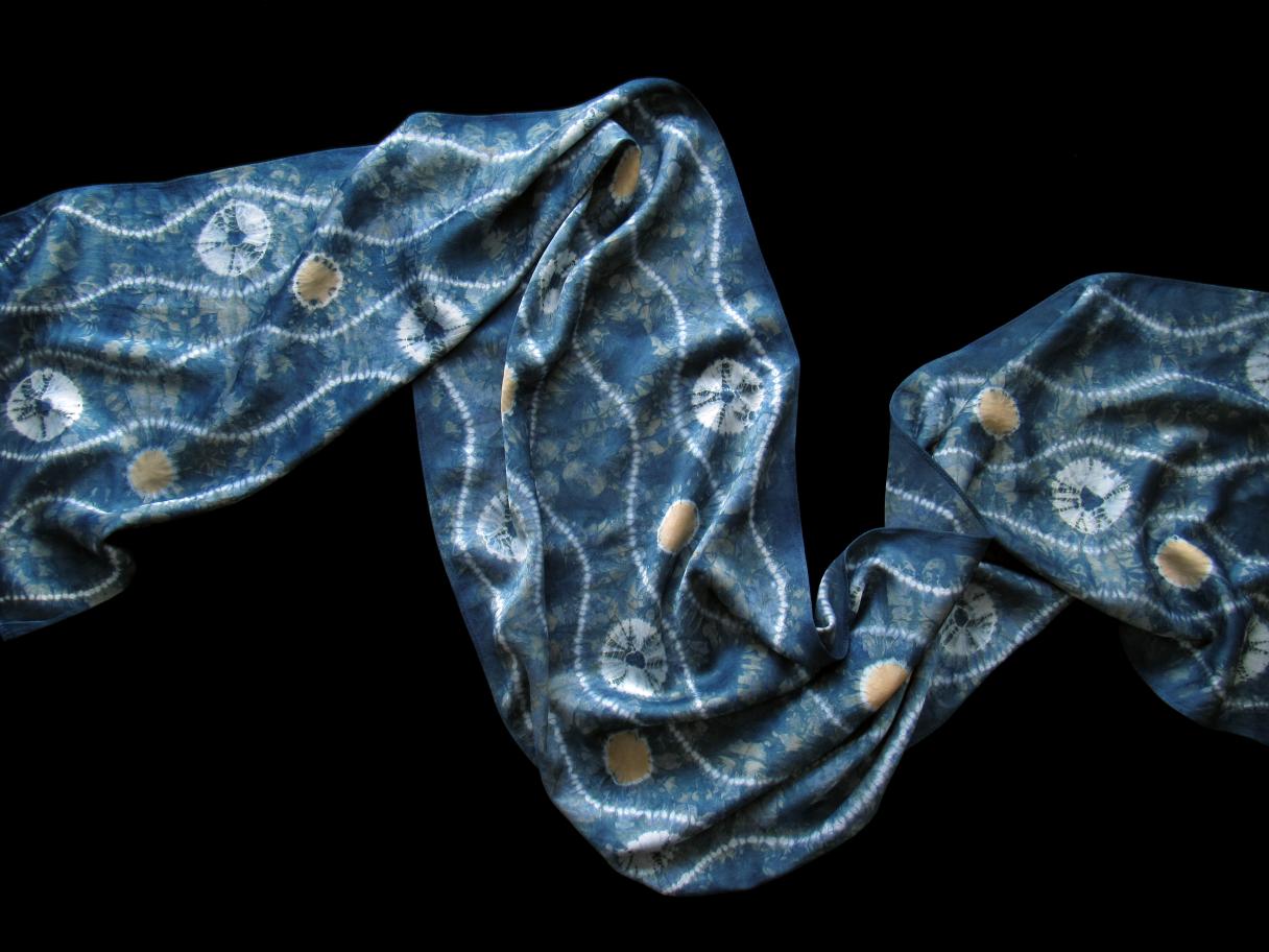 A hand-dyed indigo scar with white patterns on a black background