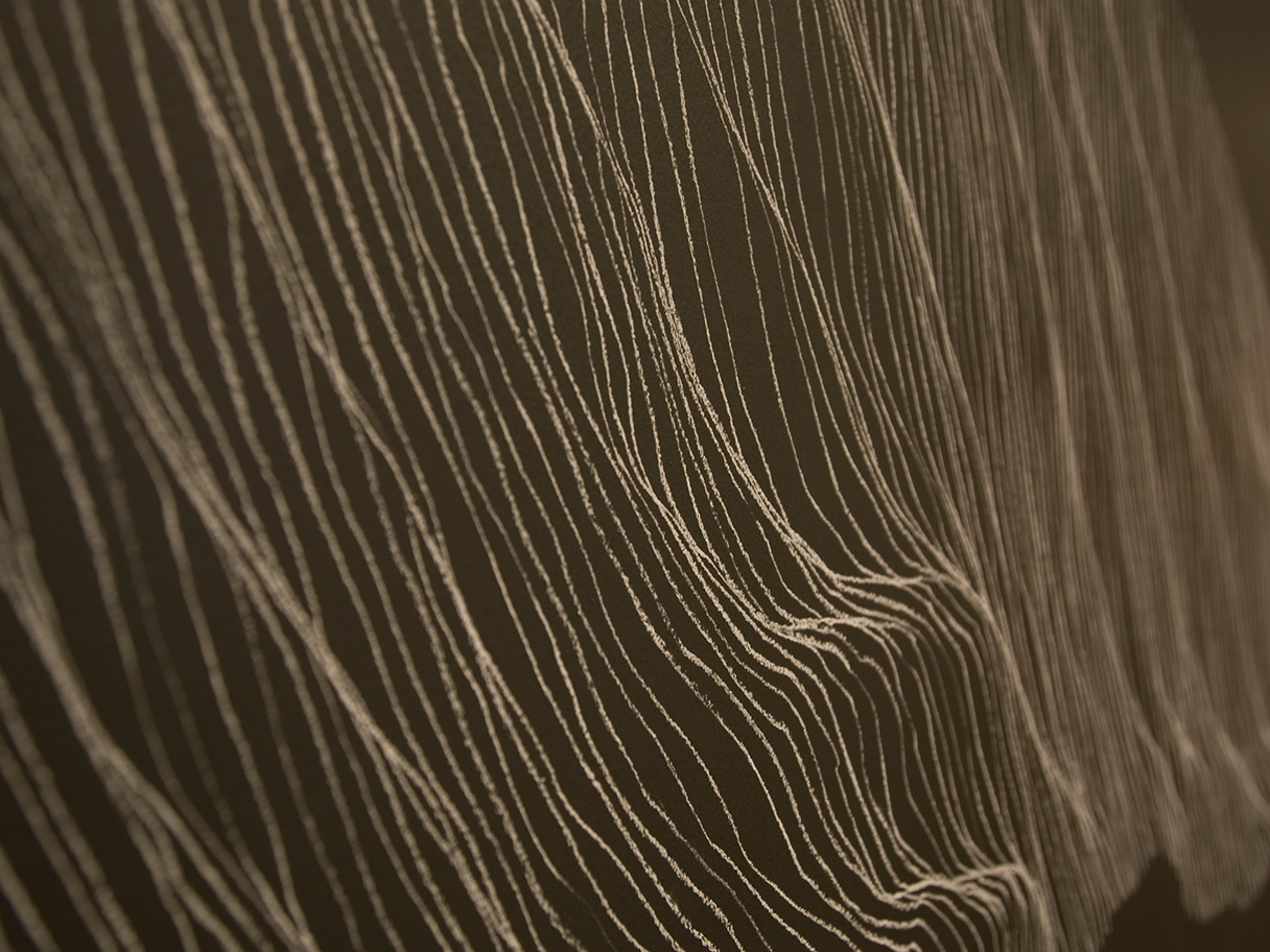 Wavy white lines against a dark grey background