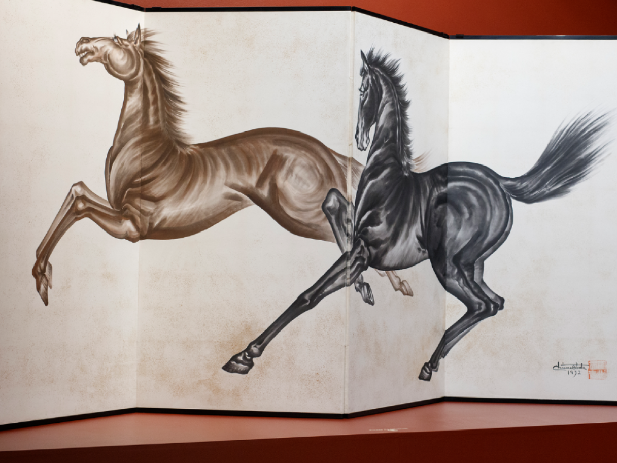 Layer by Layer A painted screen of two galloping horses. One is brown and the other is black.