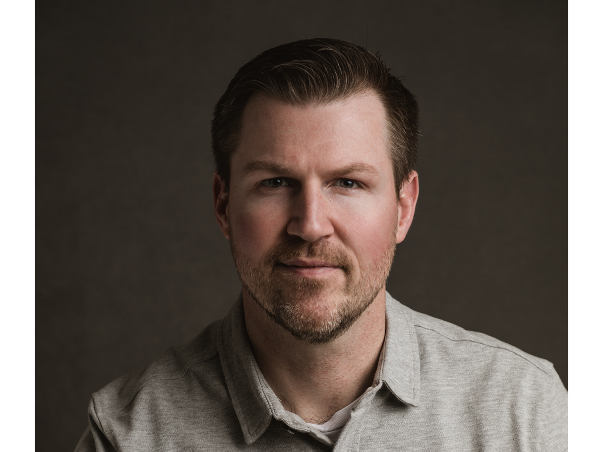 a portrait of a middle-aged, white man with brown hair and short facial hair.