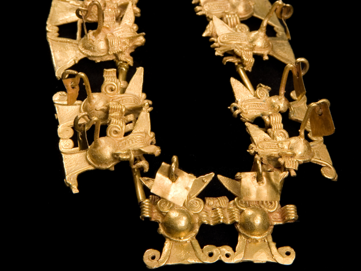 A golden necklace with double bat effigies.