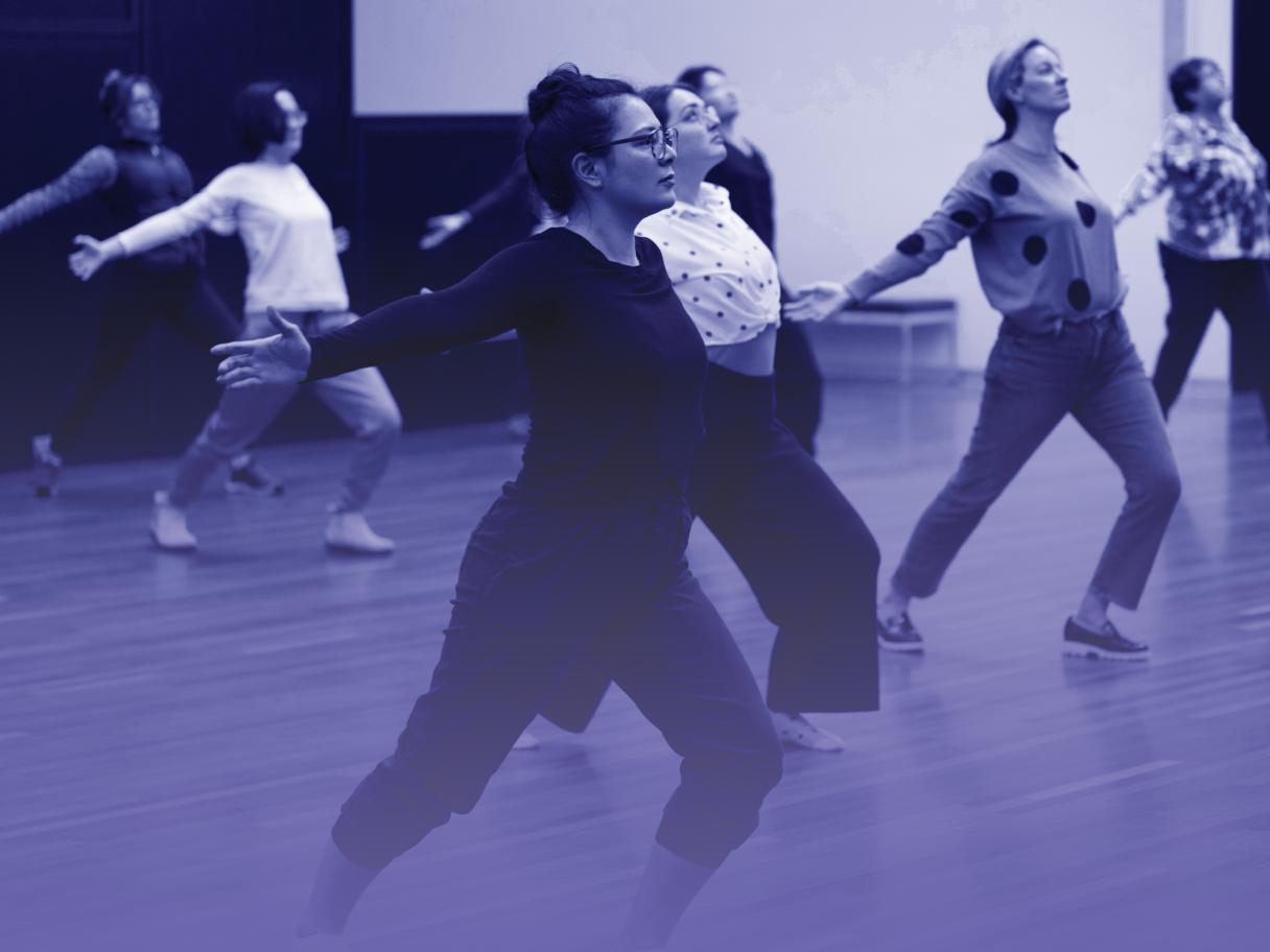 A group of people practice tai chi.