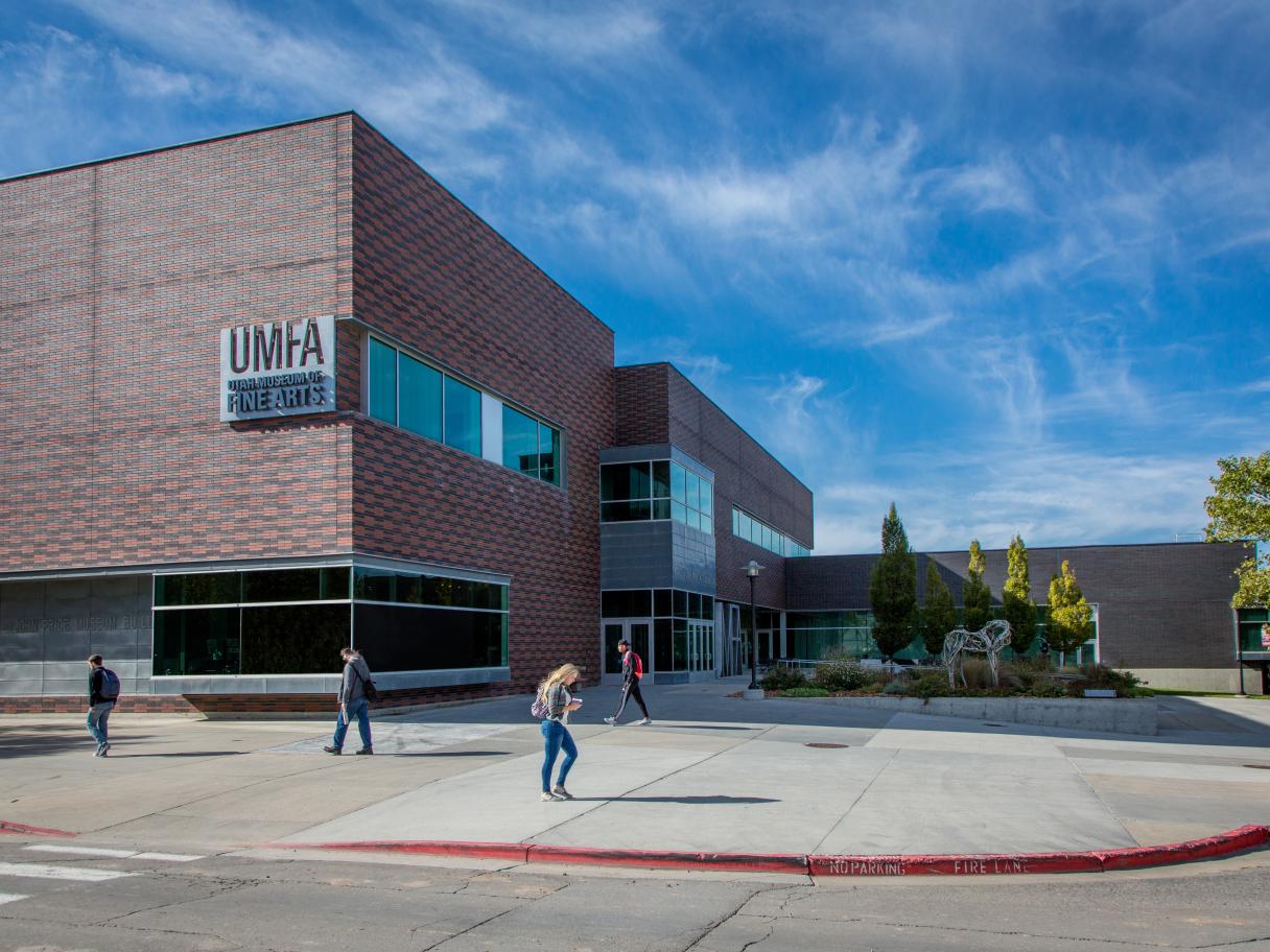 The exterior of the UMFA, students walk past the building.