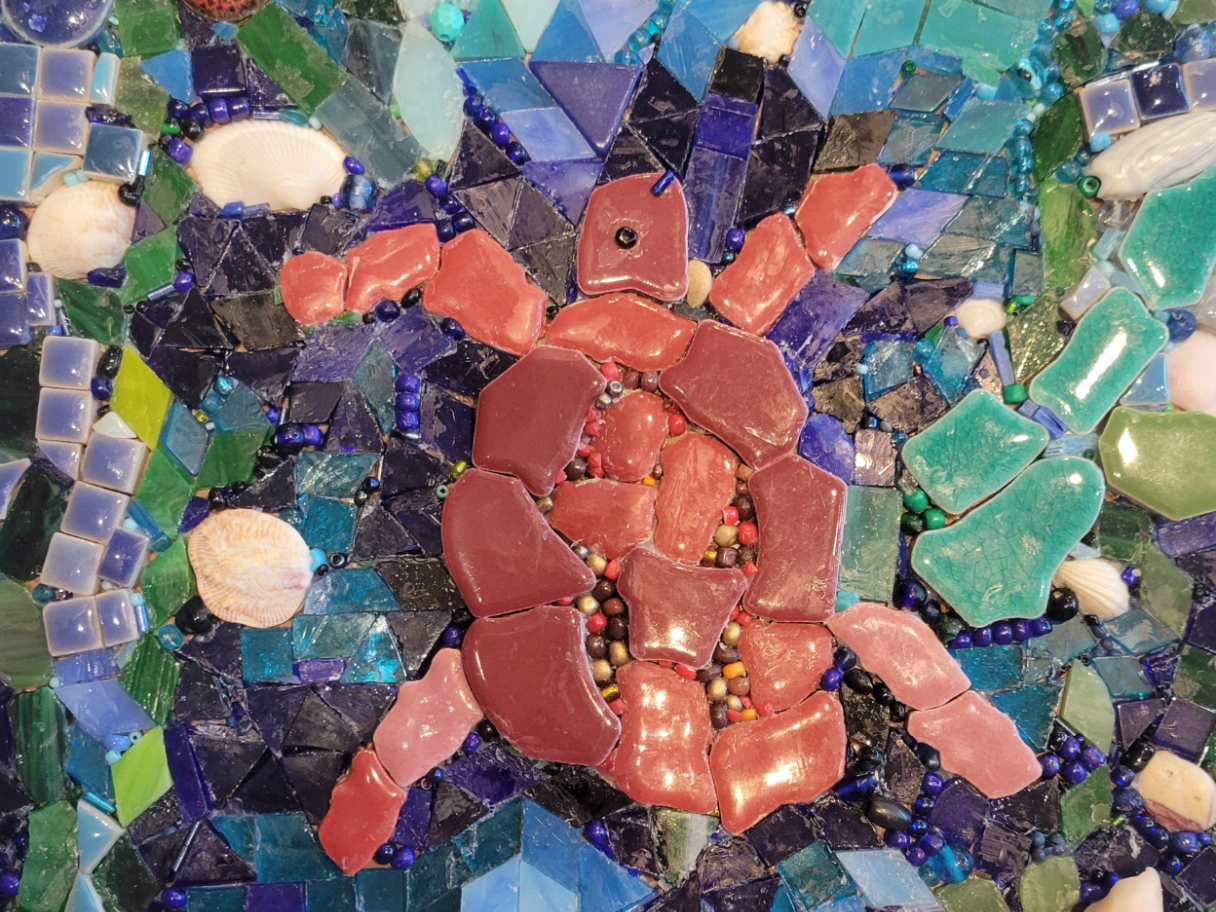 A mosaic of a red turtle.