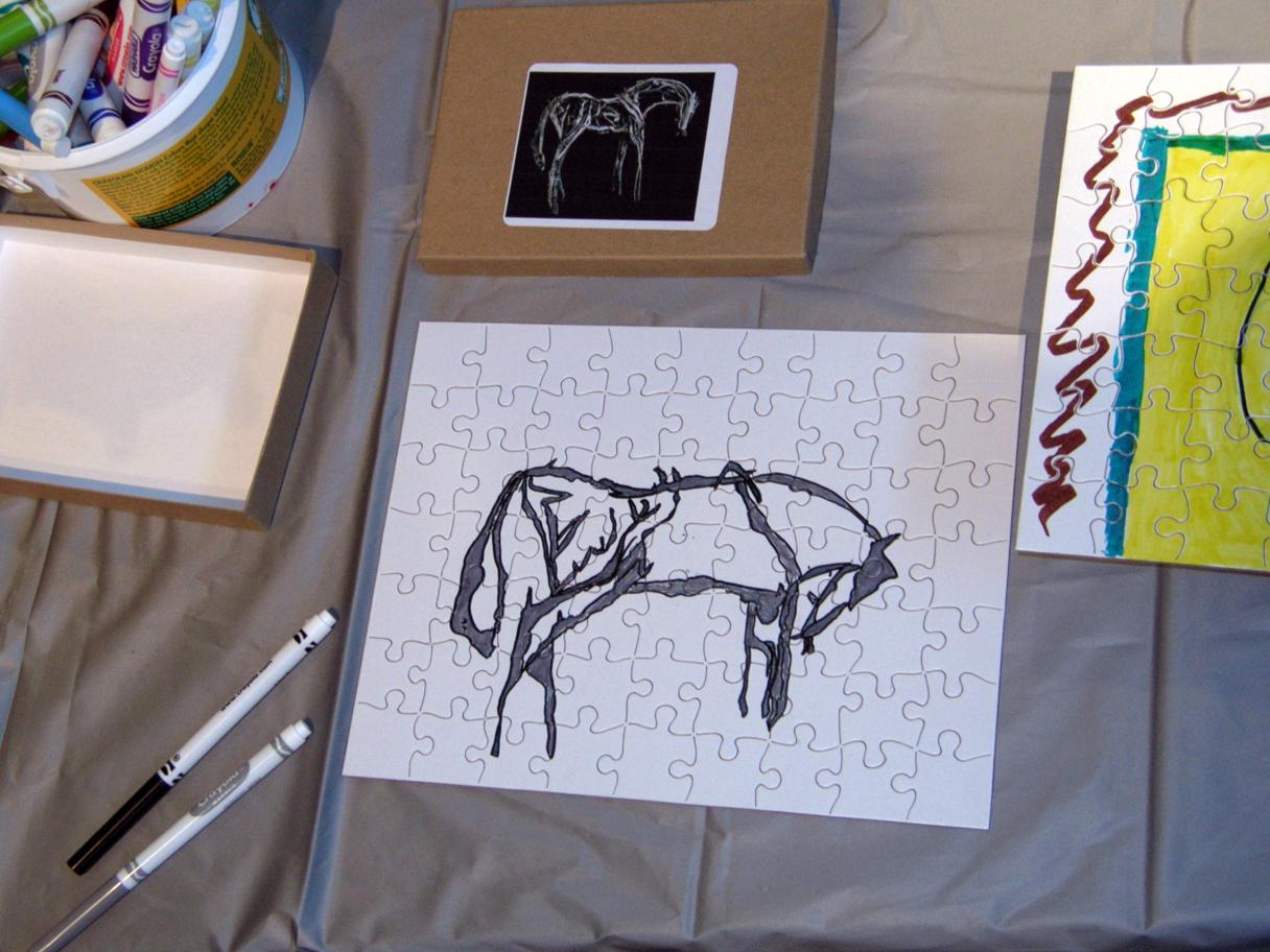 A white puzzle with a horse drawn in black marker. 