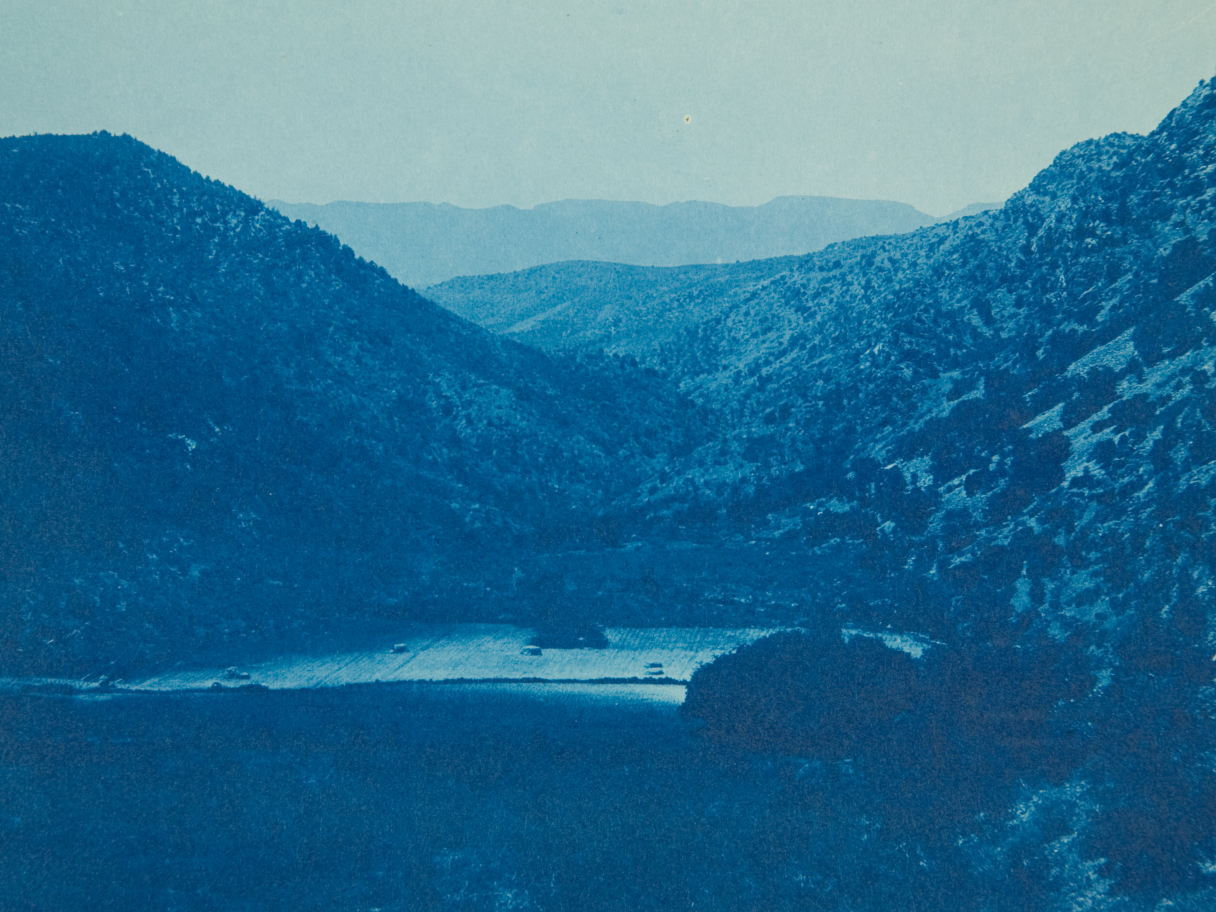 A blue cyanotype photo of a valley.